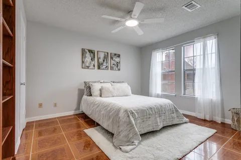 a bedroom with a large bed and a window