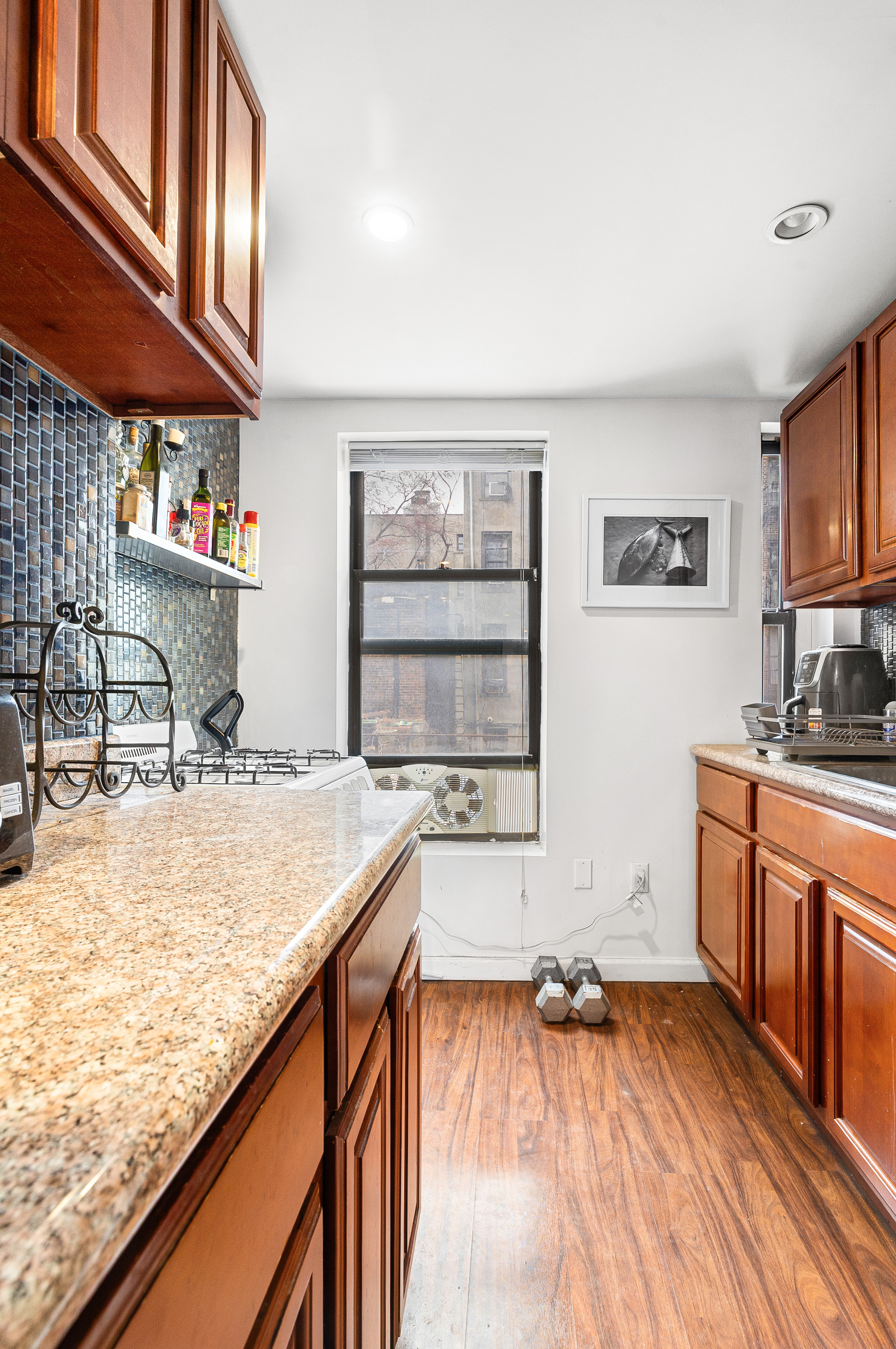 82 East 7th Street, Unit 2 Manhattan, NY 10003 - Photo 6 of 11 a kitchen with a sink stove and cabinets