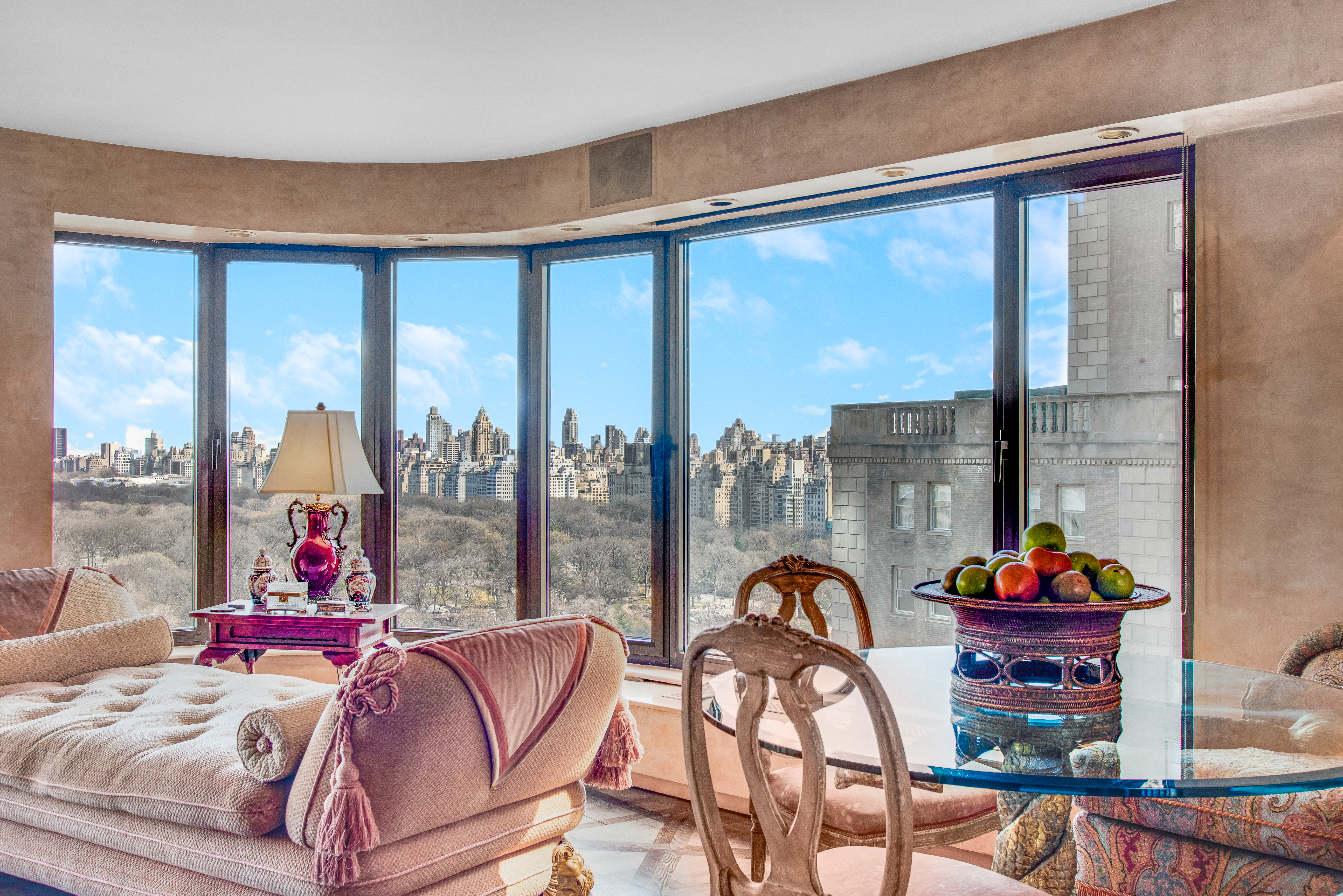 200 Central Park South, Unit 24A Manhattan, NY 10019 - Photo 7 of 23 a living room with furniture and a floor to ceiling window