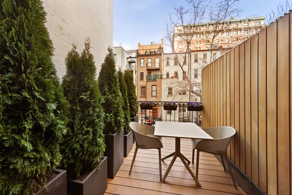 a view of a balcony dining table and chairs