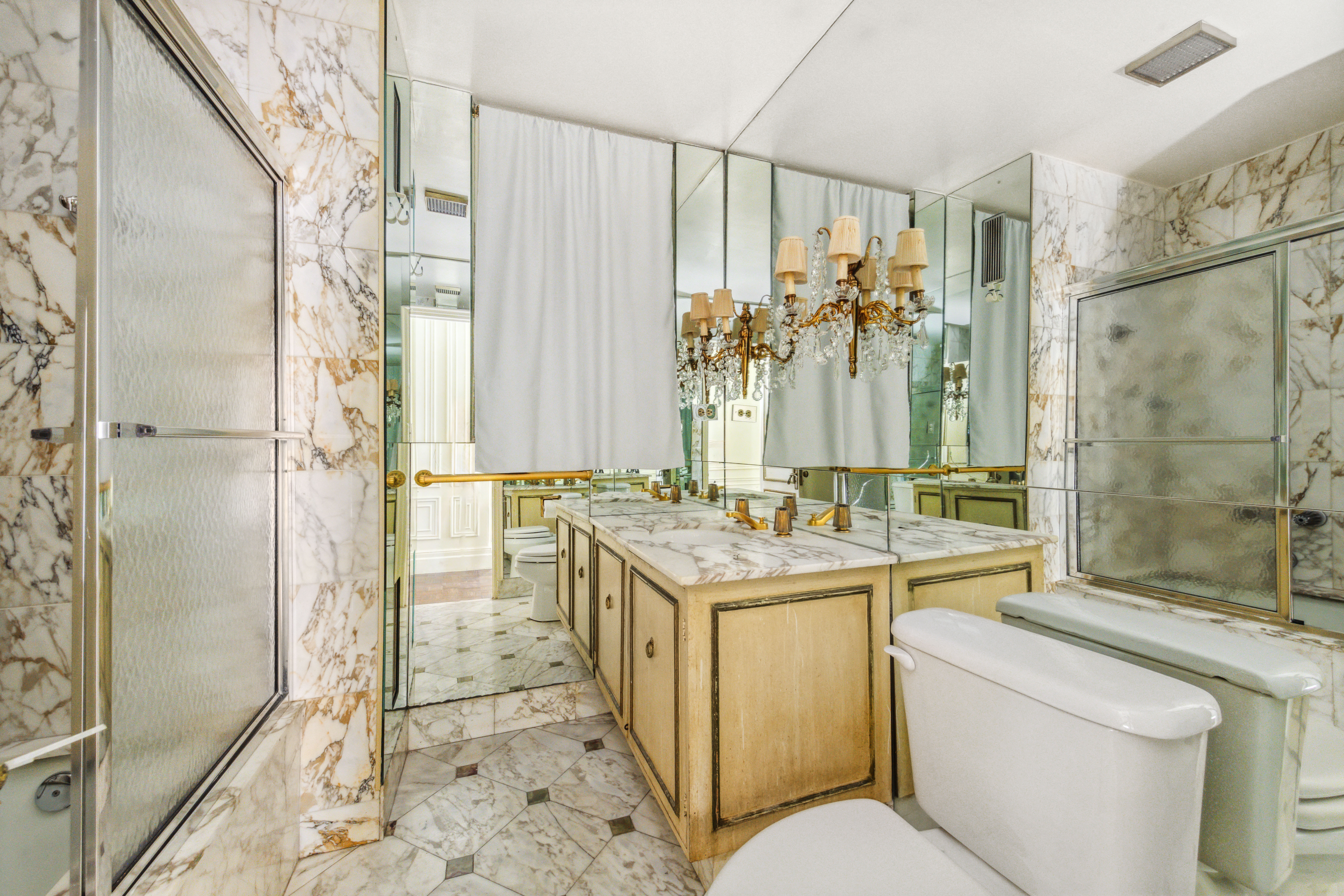 130 East 67th Street, Unit 9C Manhattan, NY 10065 - Photo 19 of 20 a bathroom with a sink a toilet and shower