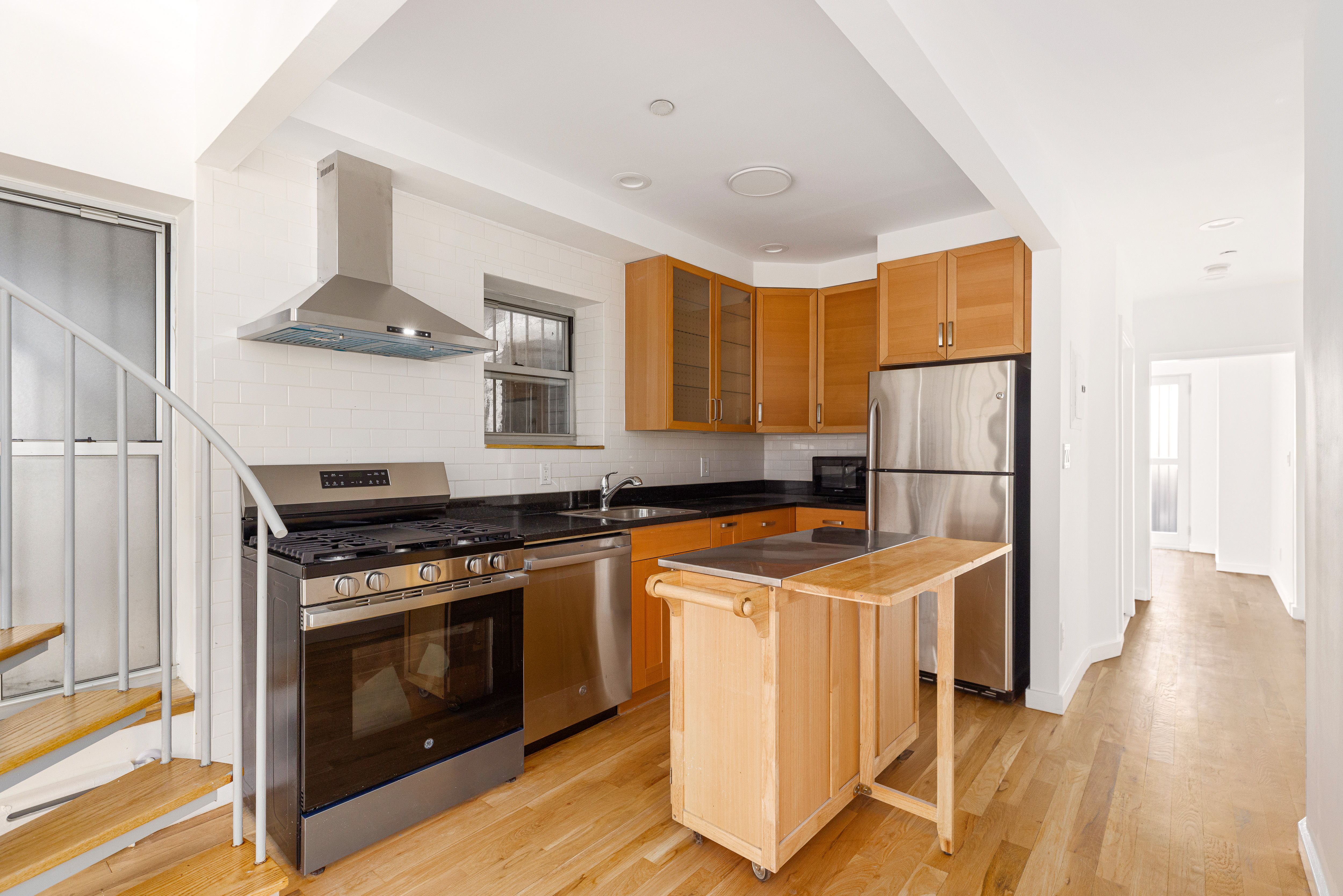 239 East 7th Street, Unit 1 Manhattan, NY 10009 - Photo 3 of 9 a kitchen with a stove and a refrigerator