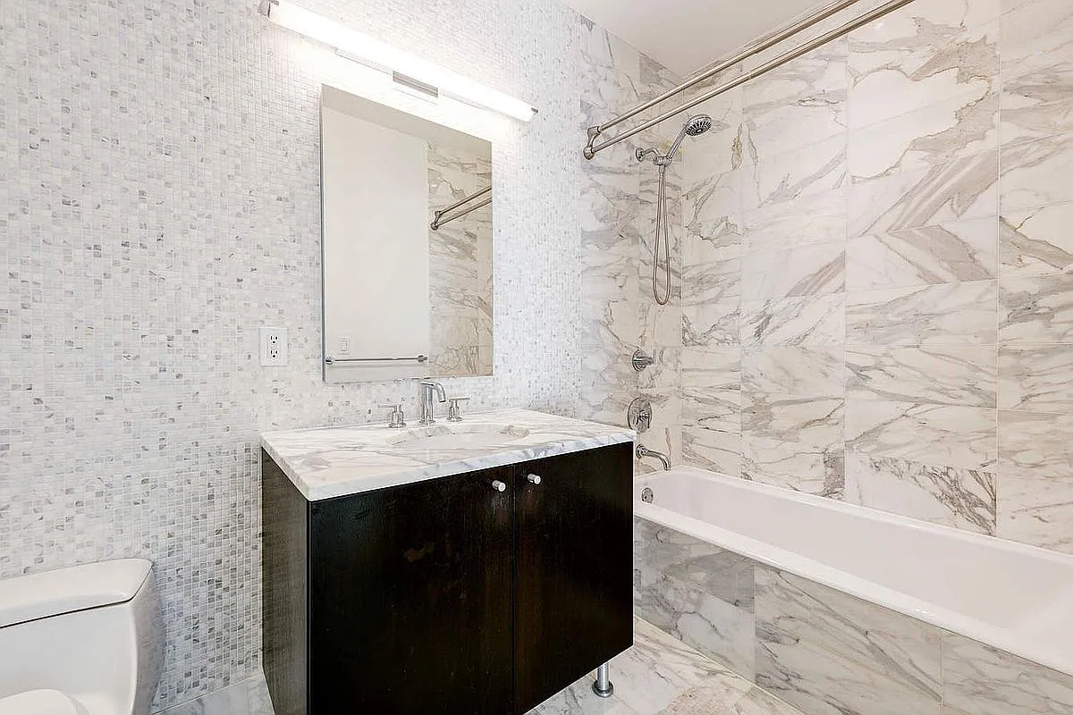 46-30 Center Boulevard, Unit 1209 Queens, NY 11109 - Photo 5 of 26 a bathroom with a sink and a mirror