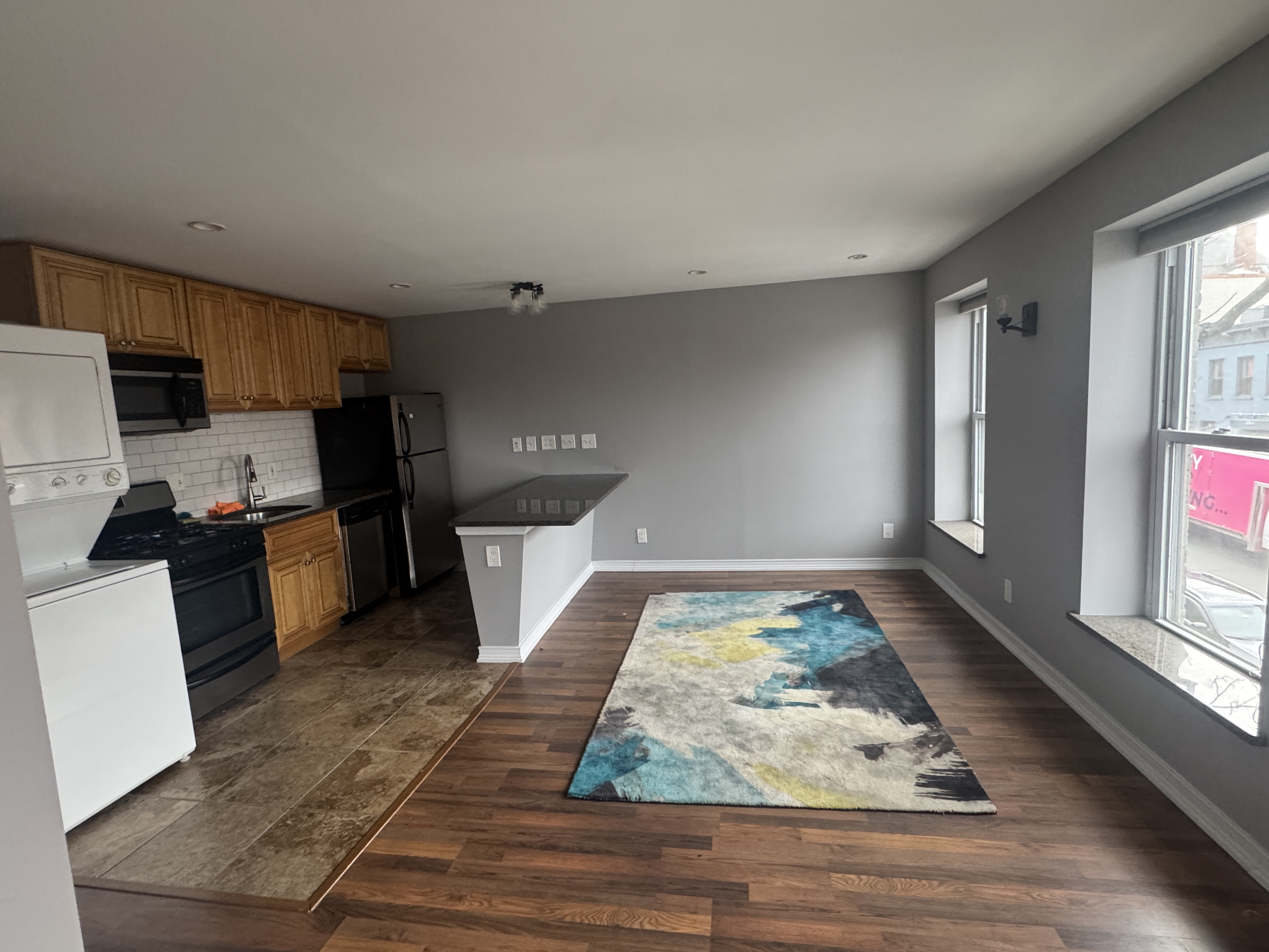 a kitchen with wooden floors and a appliances