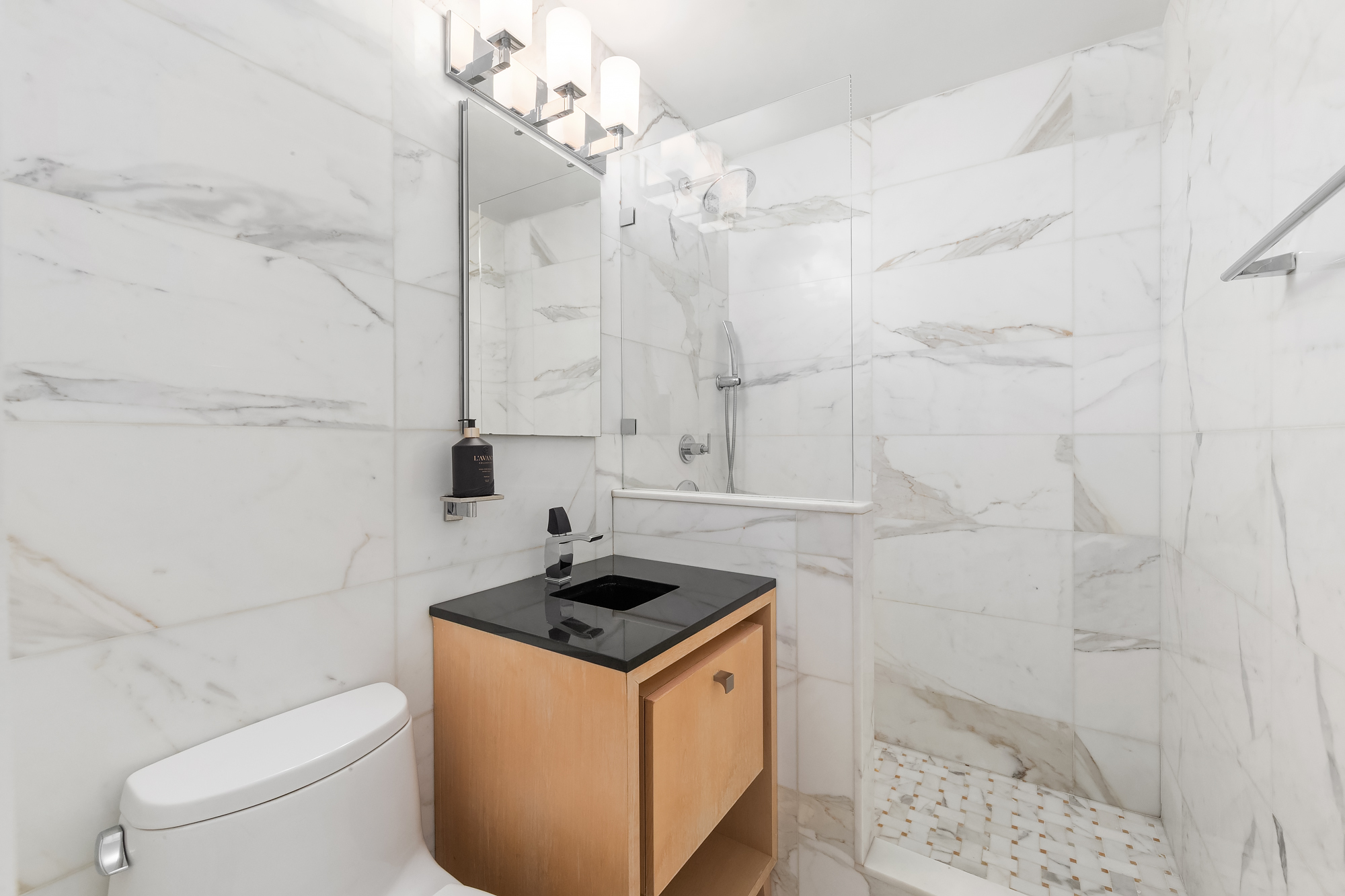 101 West 12th Street, Unit 12B Manhattan, NY 10011 - Photo 8 of 10 a bathroom with a sink a toilet and shower