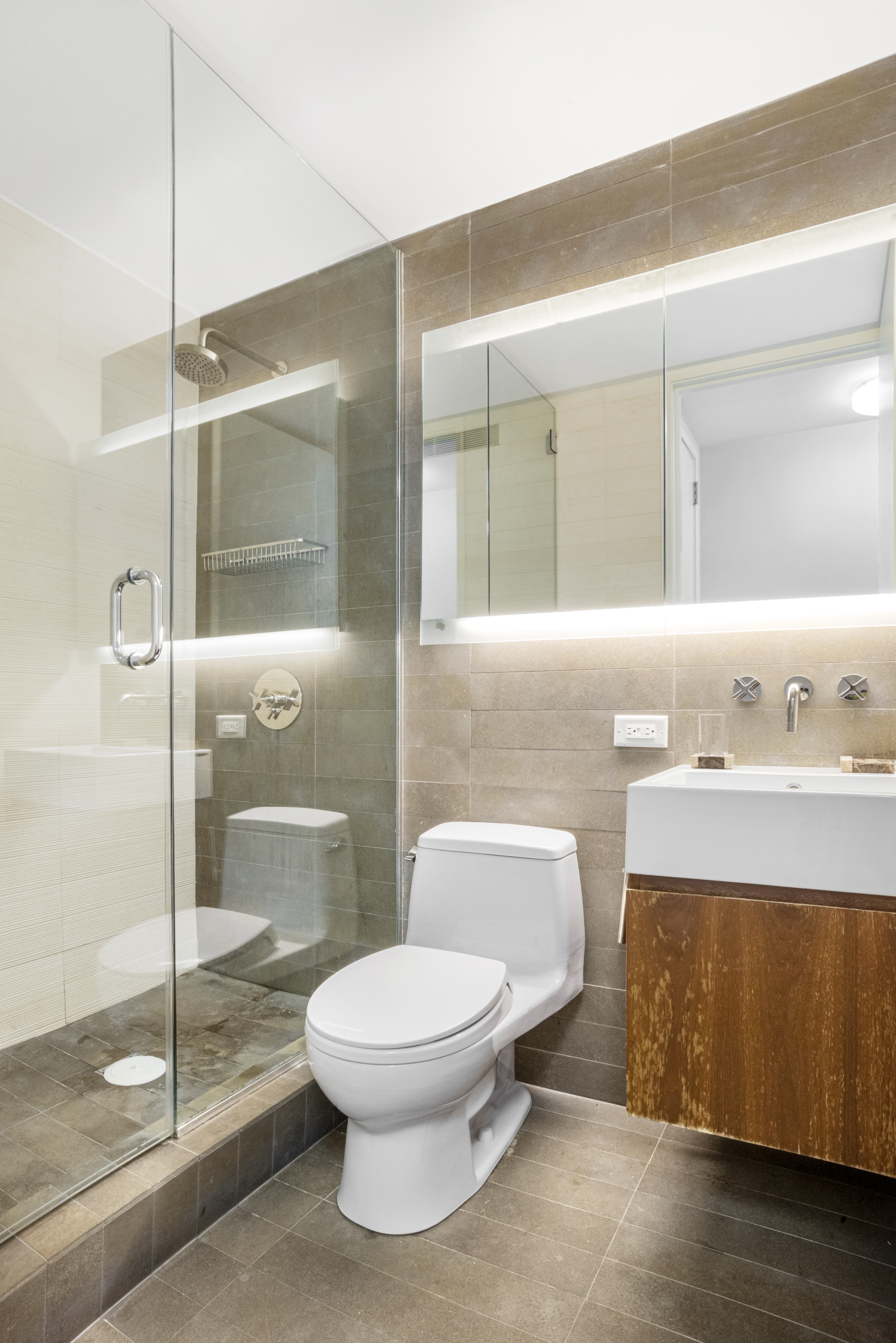515 East 72nd Street, Unit 25E Manhattan, NY 10021 - Photo 5 of 11 a bathroom with a toilet a sink and a shower