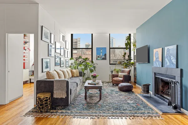a living room with furniture a fireplace and a table
