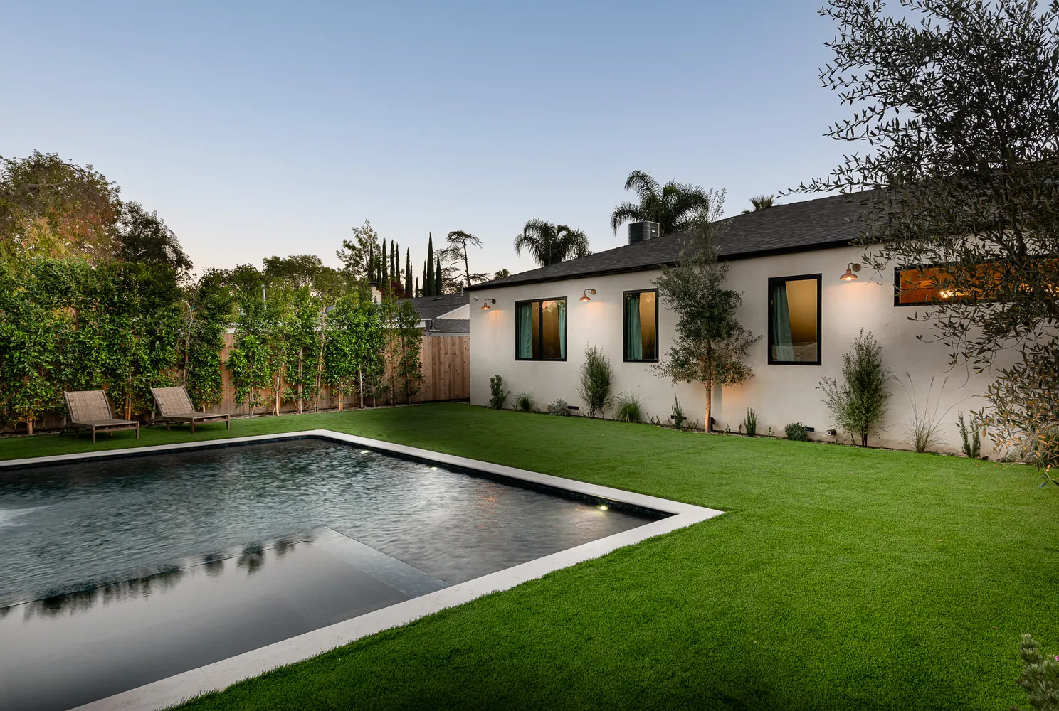 a view of a backyard with plants and a patio