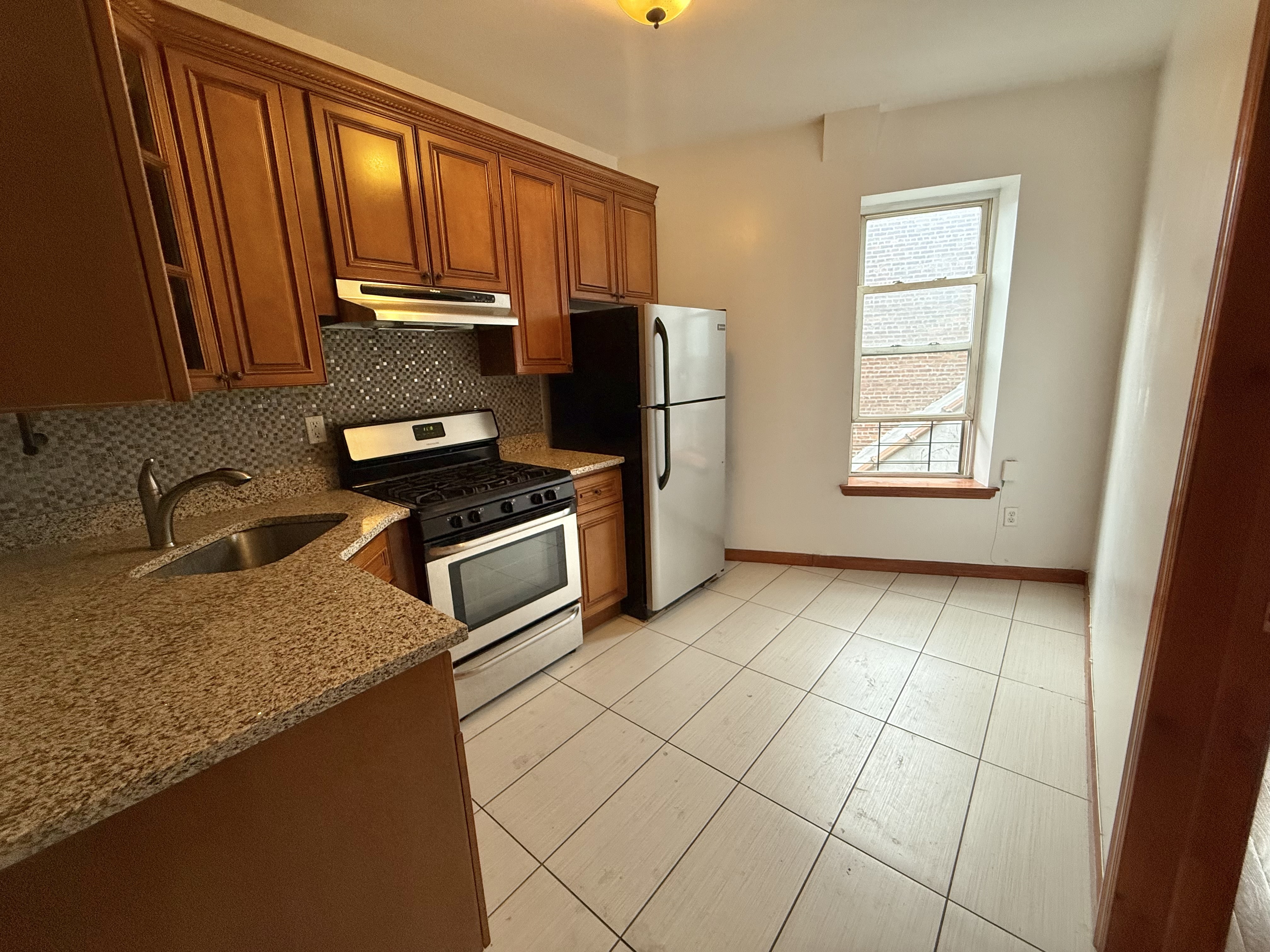 386 Prospect Place Brooklyn, NY 11238 - Photo 3 of 7 a kitchen with stainless steel appliances granite countertop a stove a sink and a microwave