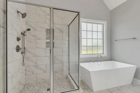 a bathroom with a bathtub and shower