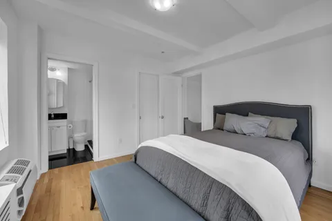 a bedroom with a bed and a lamp