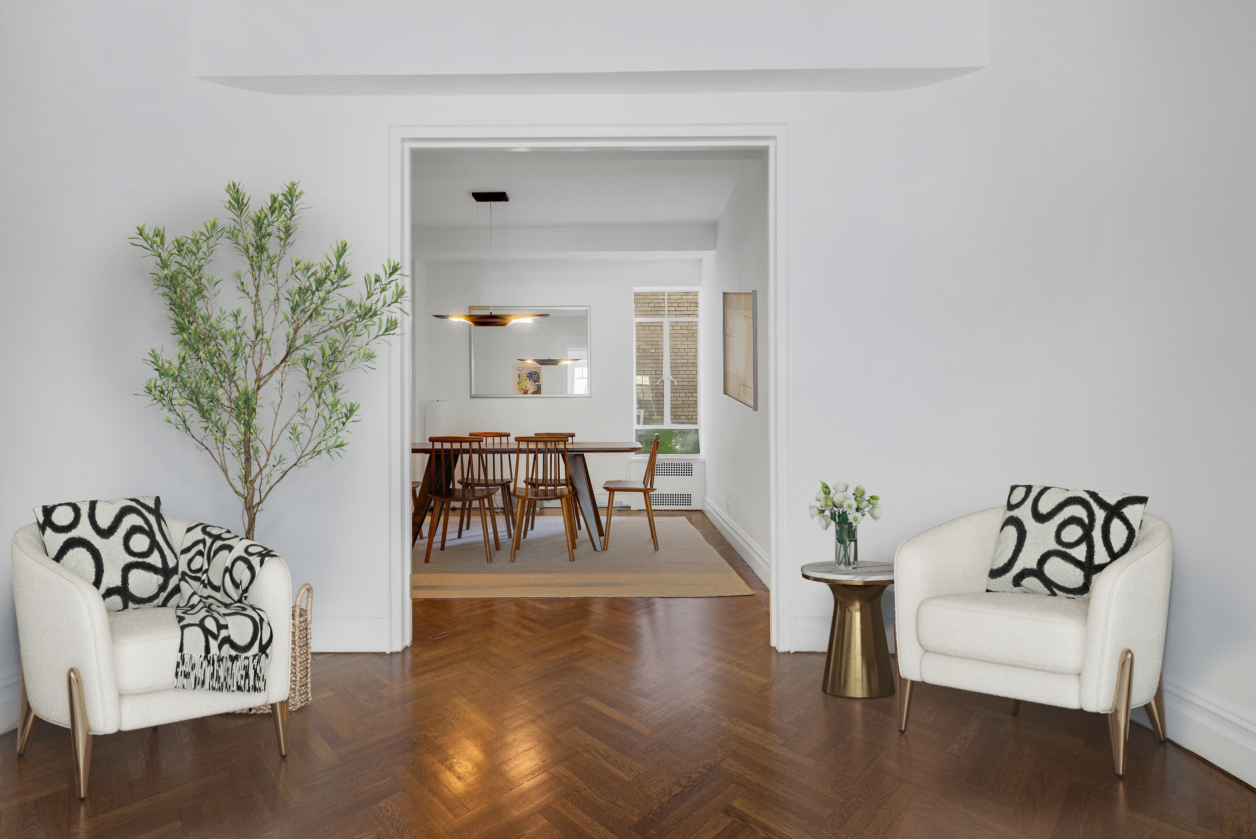 44 East 67th Street, Unit 6C Manhattan, NY 10065 - Photo 2 of 9 a living room with furniture and a potted plant