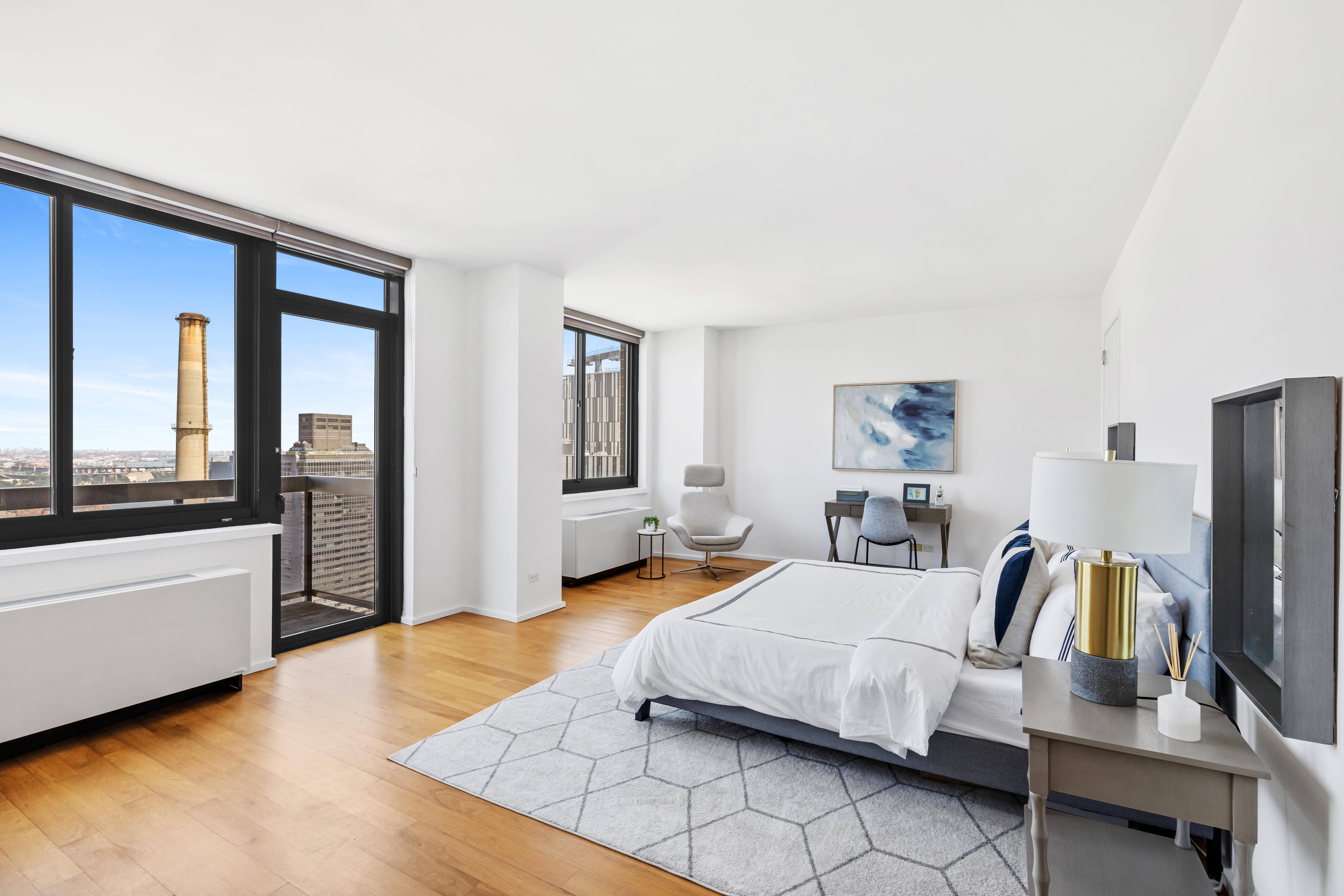 515 East 72nd Street, Unit 40E Manhattan, NY 10021 - Photo 8 of 34 a bedroom with a large bed and a couch