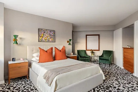 a bedroom with bed chair and window