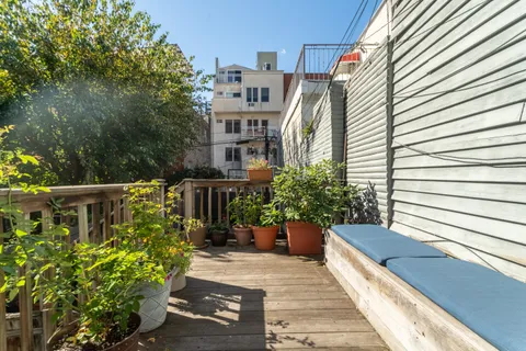a view of a house with backyard and sitting area
