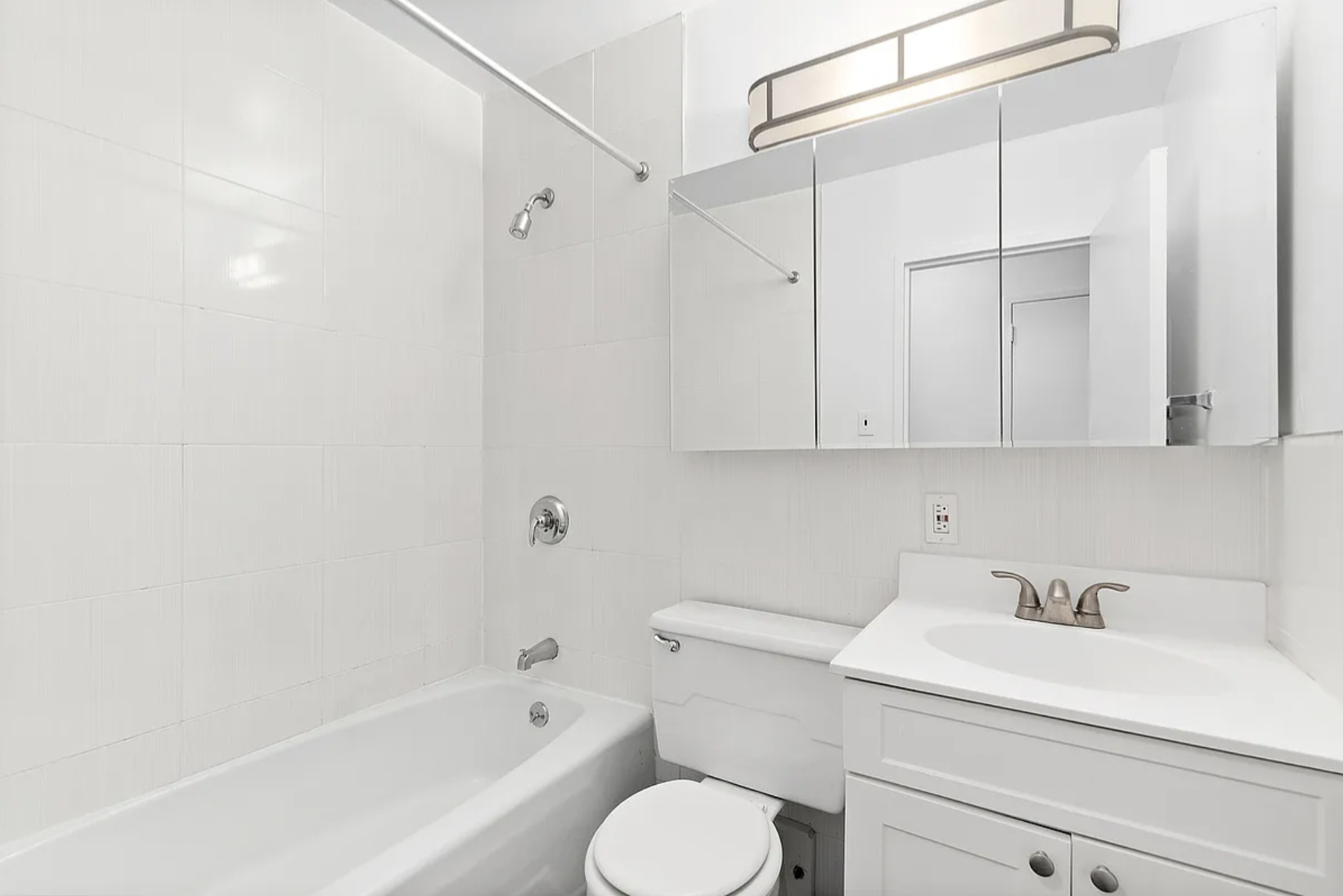 343 East 76th Street, Unit 1B Manhattan, NY 10021 - Photo 4 of 5 a bathroom with a sink toilet and shower