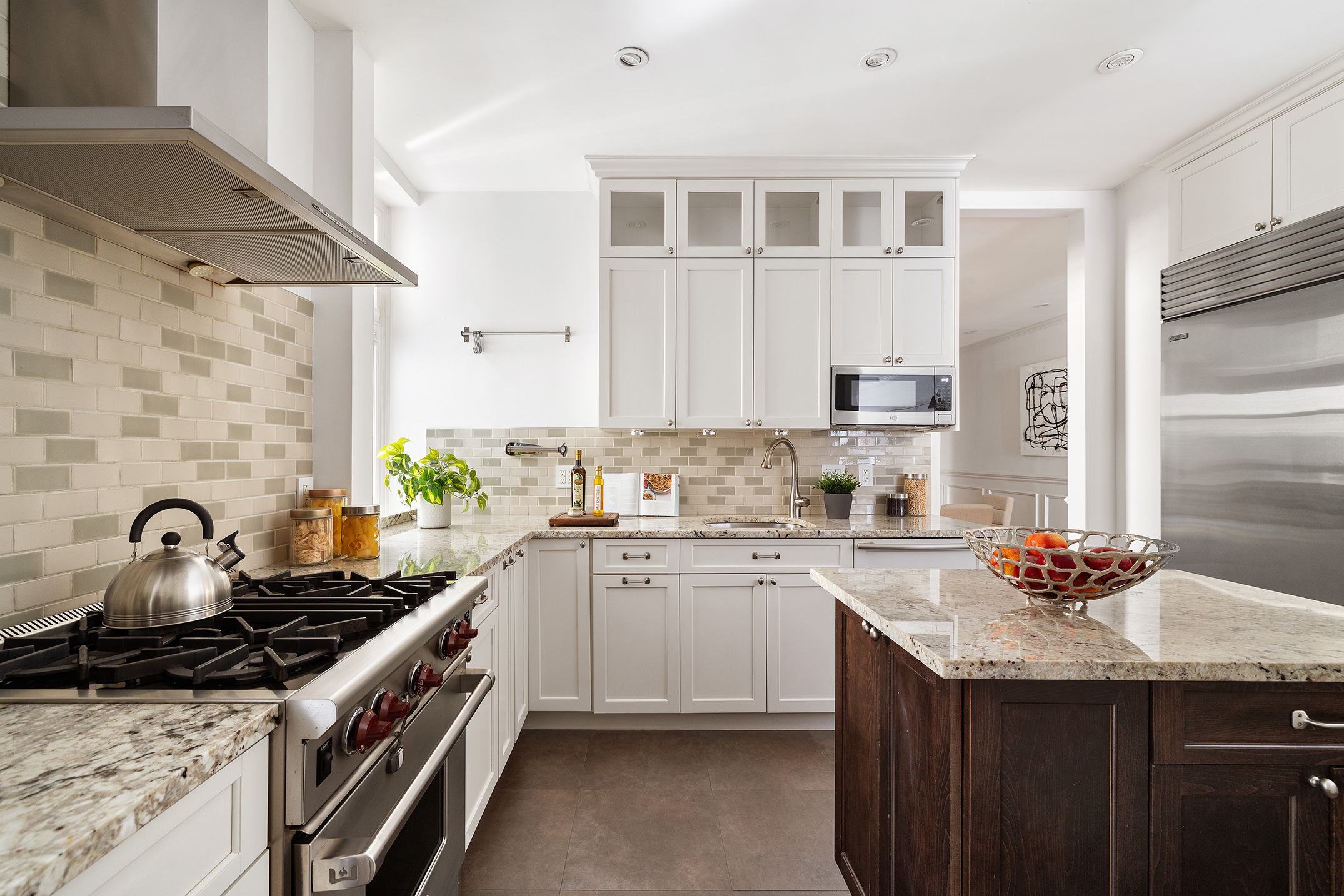 203 West 81st Street, Unit 3A Manhattan, NY 10024 - Photo 5 of 12 a kitchen with granite countertop a sink stove and cabinets