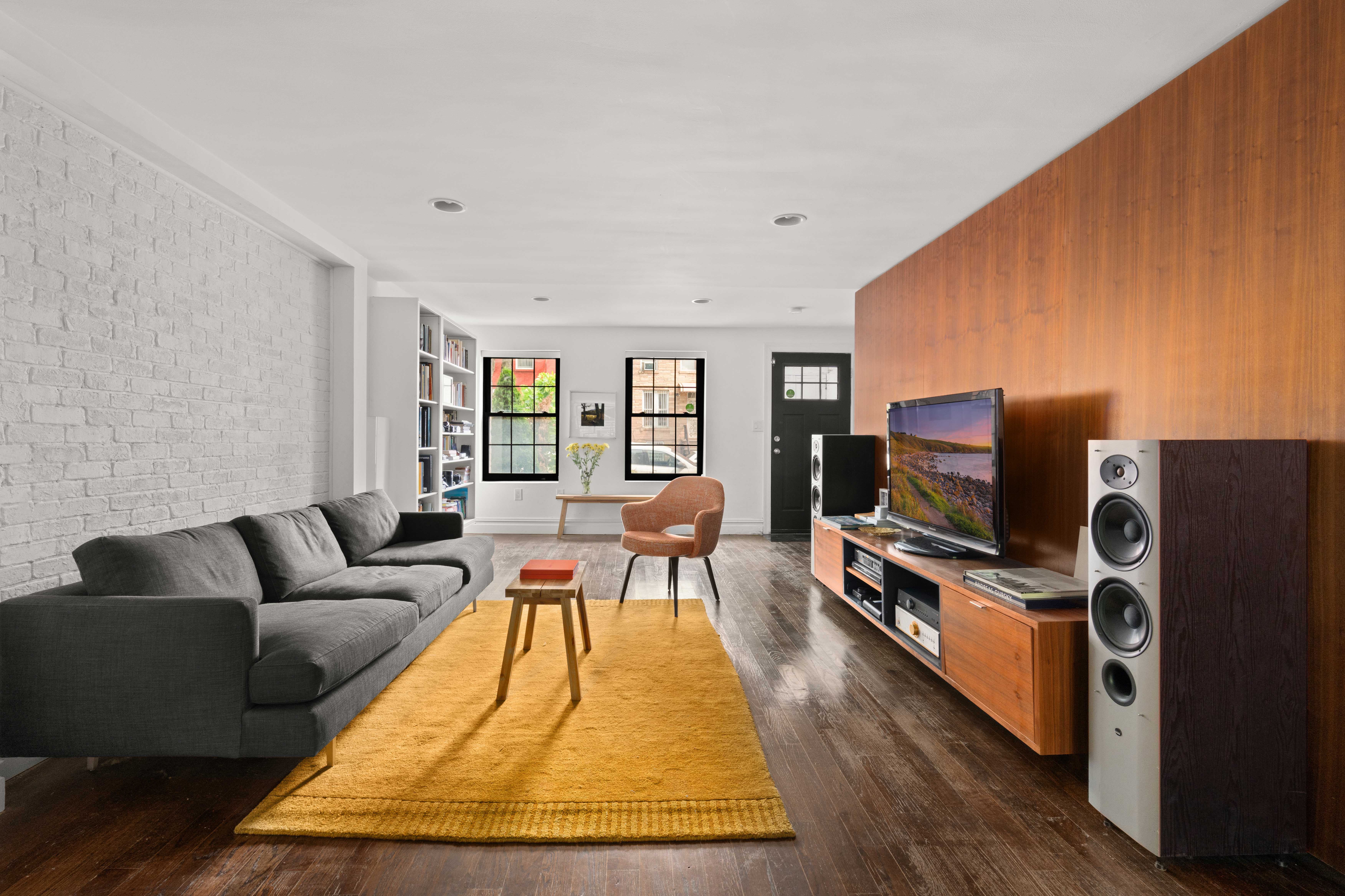 748 Madison Street, Unit 1 Brooklyn, NY 11221 - Photo 3 of 10 a living room with furniture and a flat screen tv