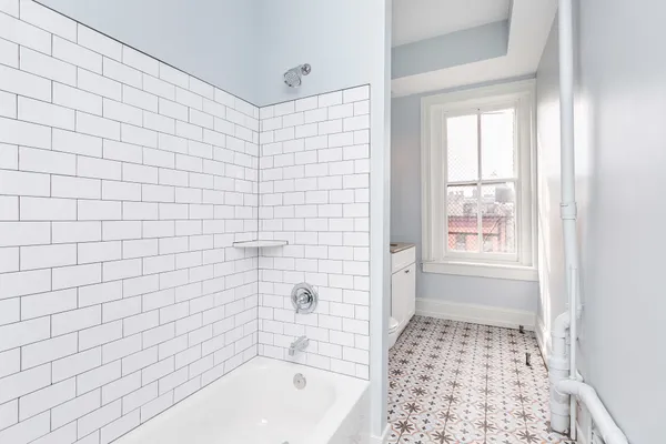 a bathroom with a toilet a sink and a window