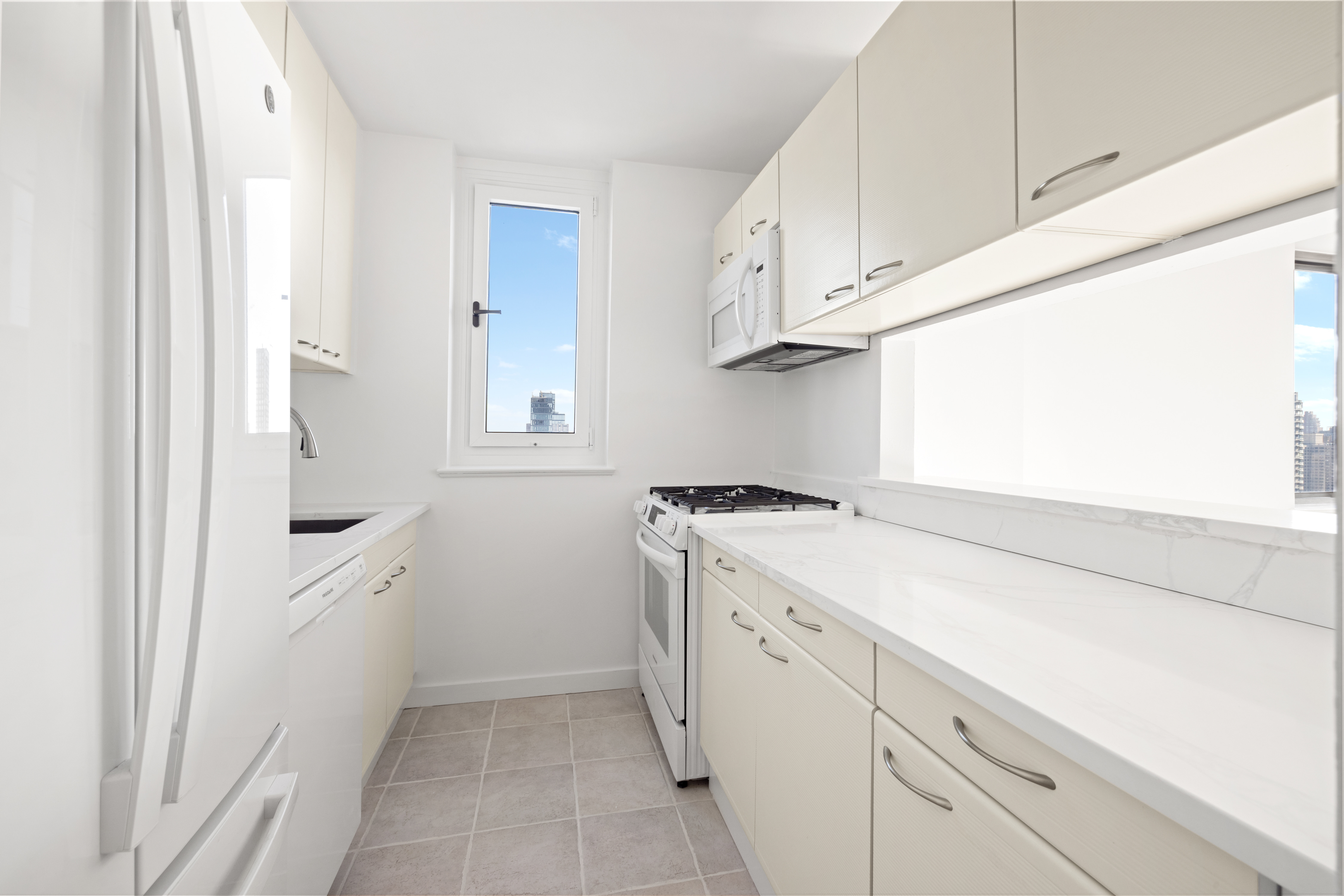 200 East 89th Street, Unit 29D Manhattan, NY 10128 - Photo 6 of 16 a utility room with cabinets washer and dryer