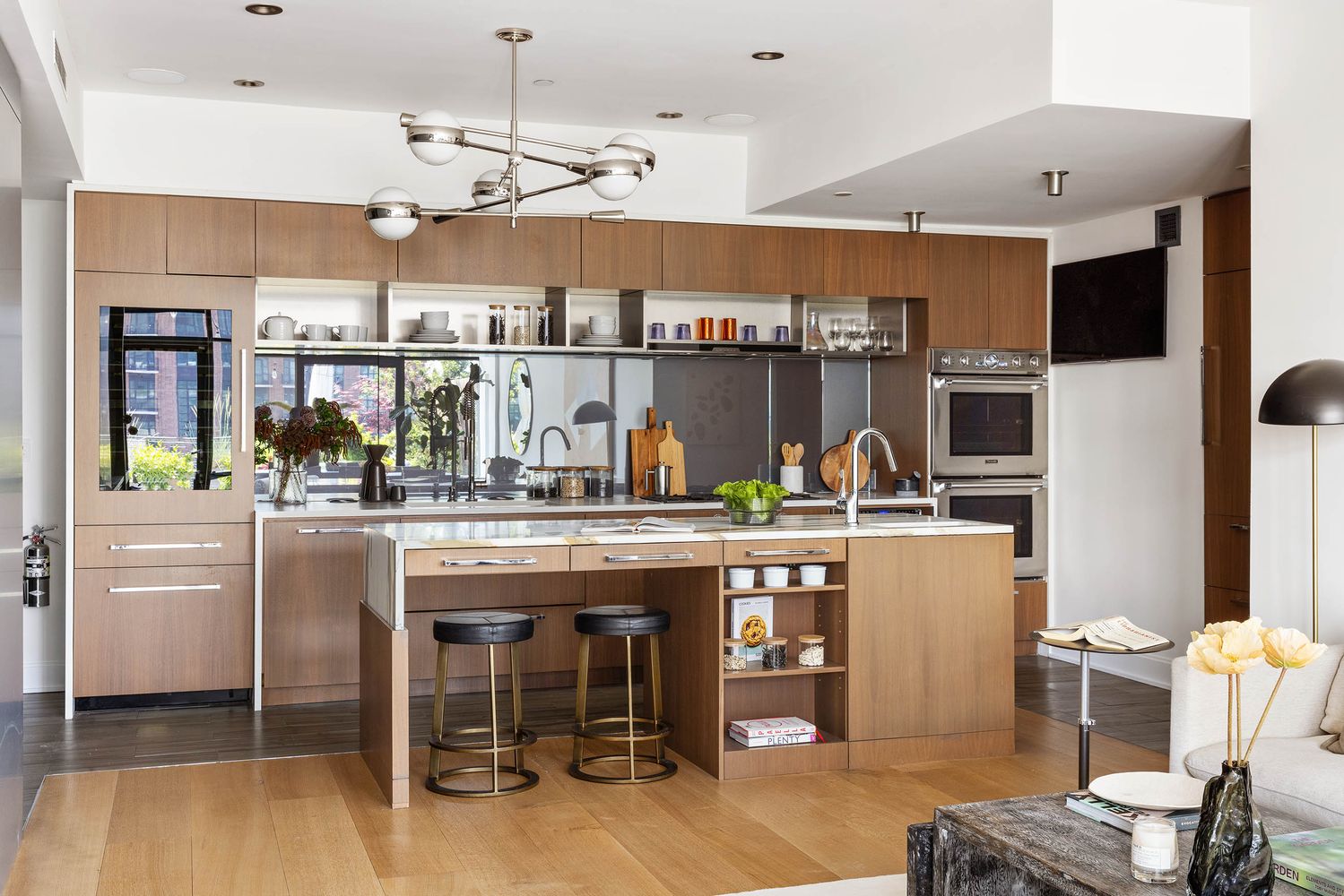 a kitchen with stainless steel appliances granite countertop a table and chairs in it