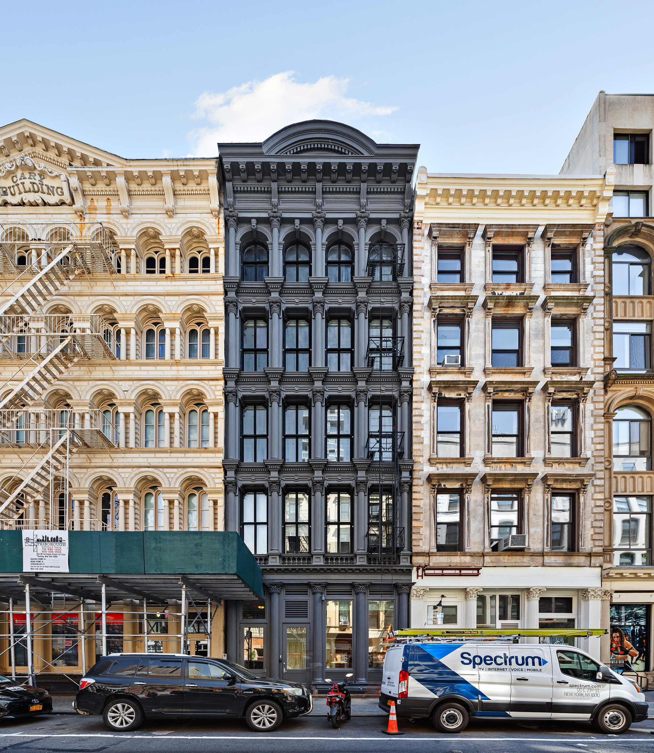 93 Reade Street, Unit 3 Manhattan, NY 10013 - Photo 11 of 12 a front view of a building with lot of cars and trees