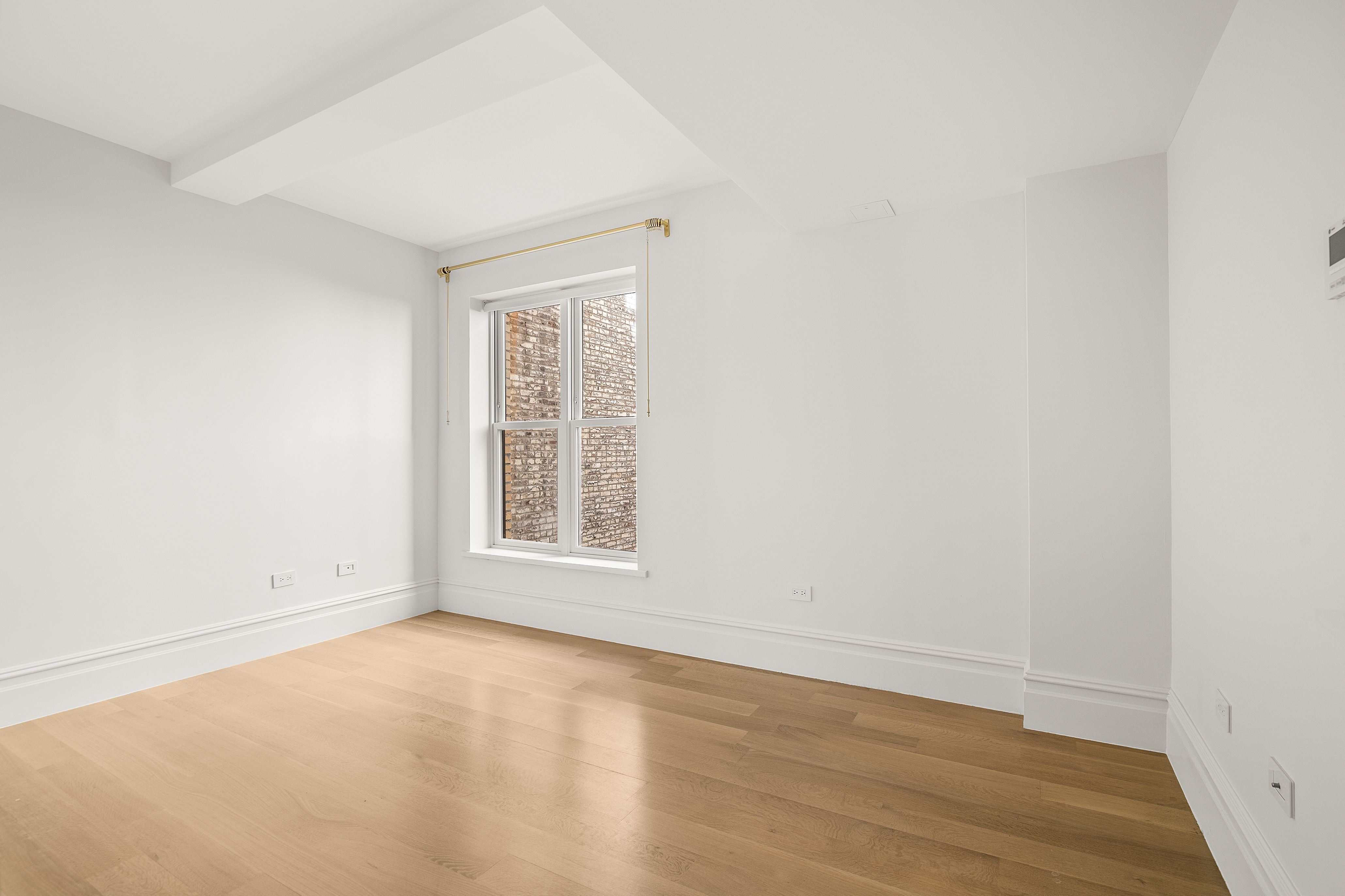 150 West 82nd Street, Unit 7A Manhattan, NY 10024 - Photo 9 of 15 an empty room with wooden floor and windows