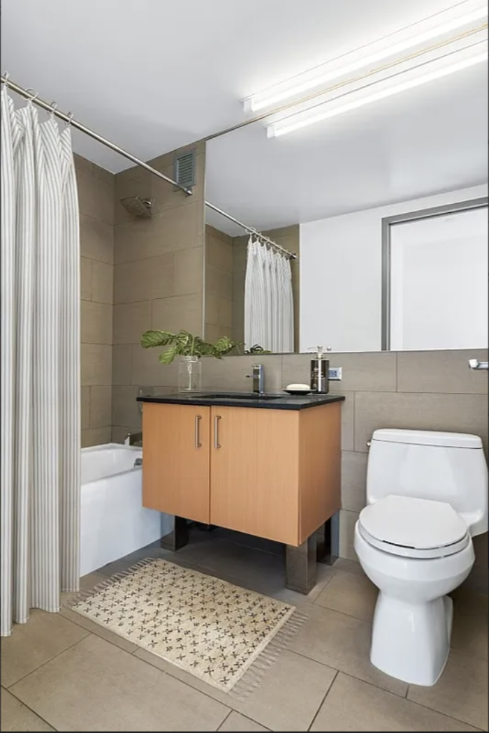 Spruce Street, Unit 12A Manhattan, NY 10038 - Photo 4 of 18 a bathroom with a sink a toilet and shower
