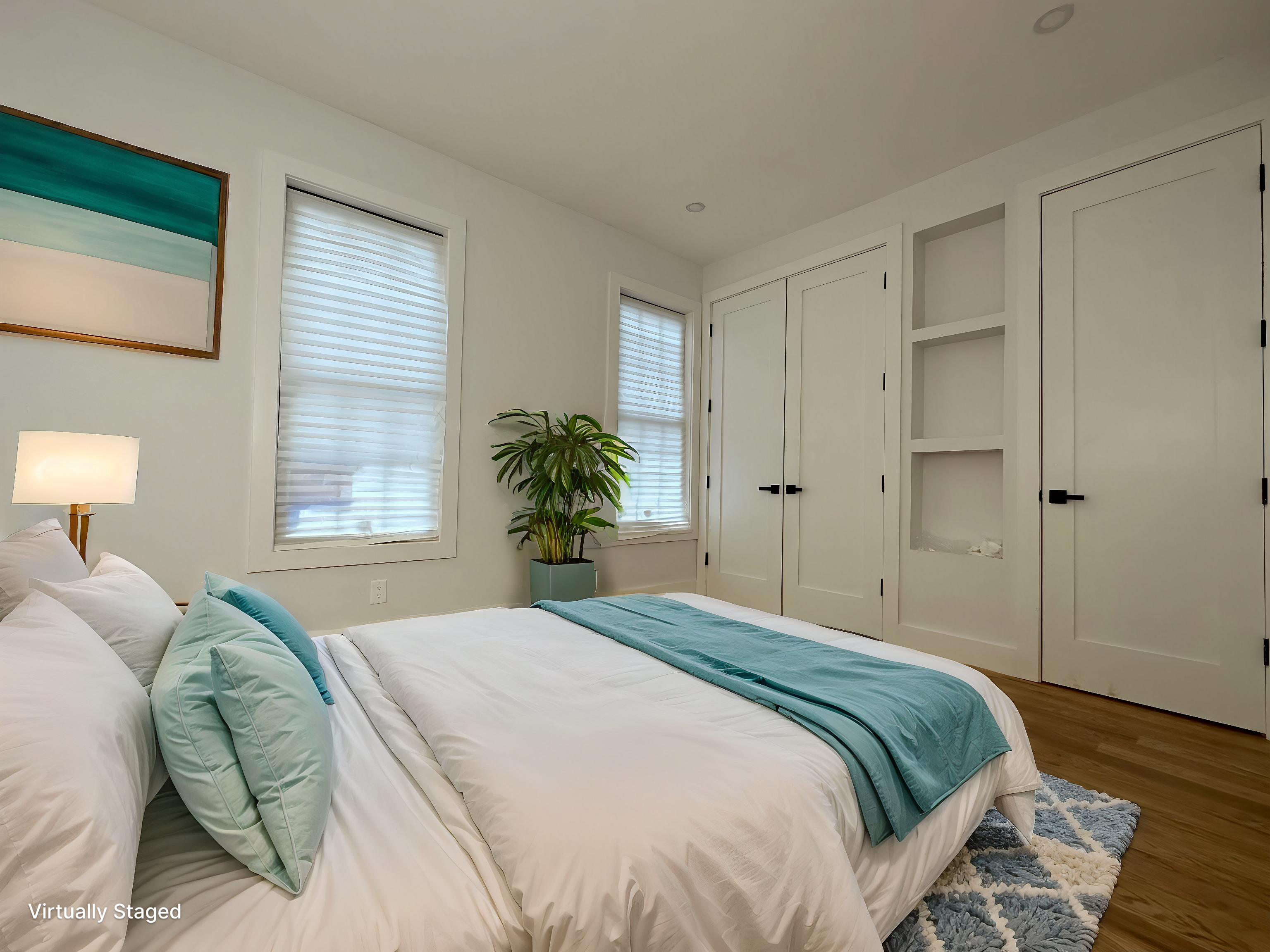 38-18 32nd Street, Unit 1 Queens, NY 11101 - Photo 2 of 6 a bedroom with a bed and a potted plant