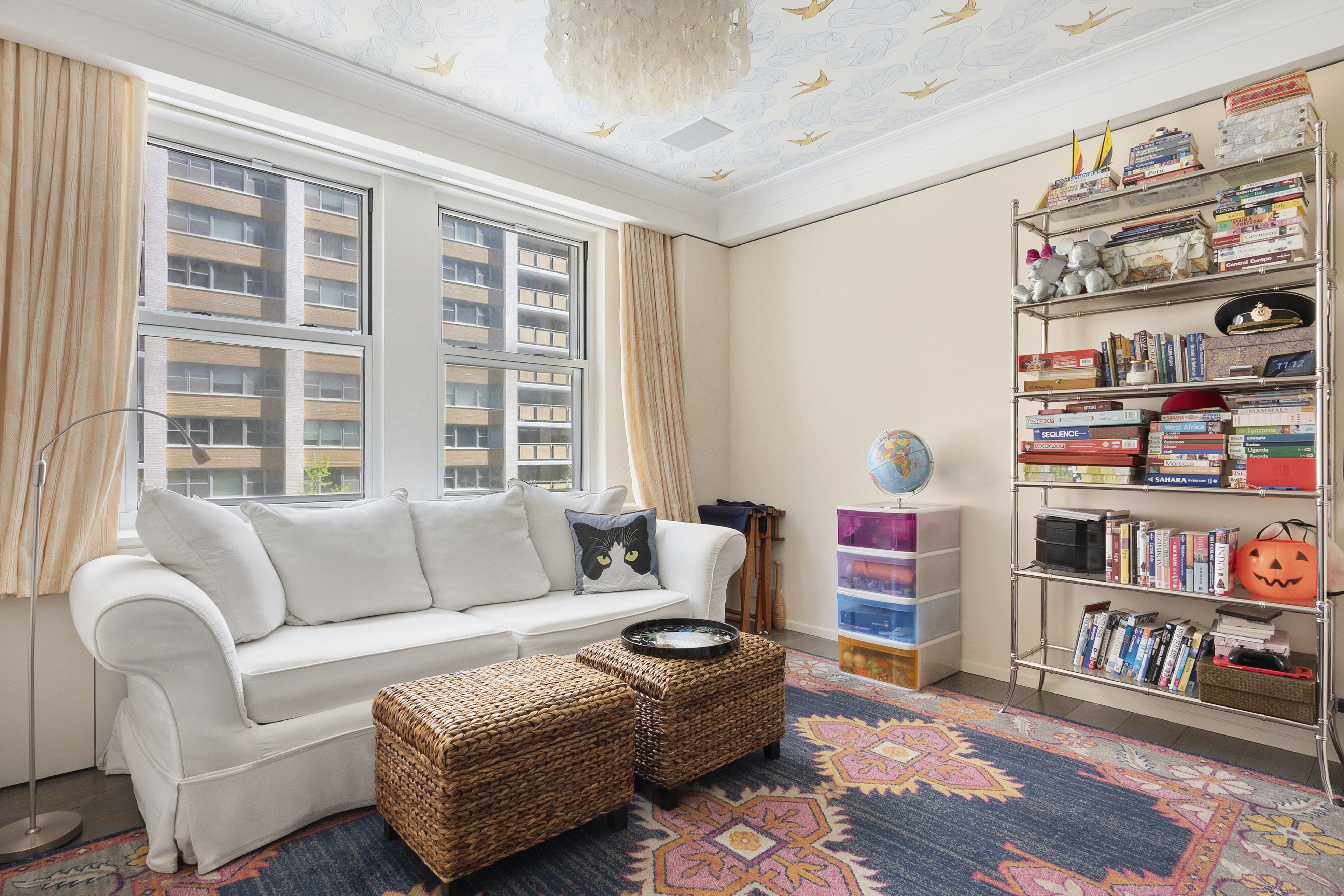 20 West 72nd Street, Unit 500 Manhattan, NY 10023 - Photo 10 of 12 a living room with furniture and a book shelf