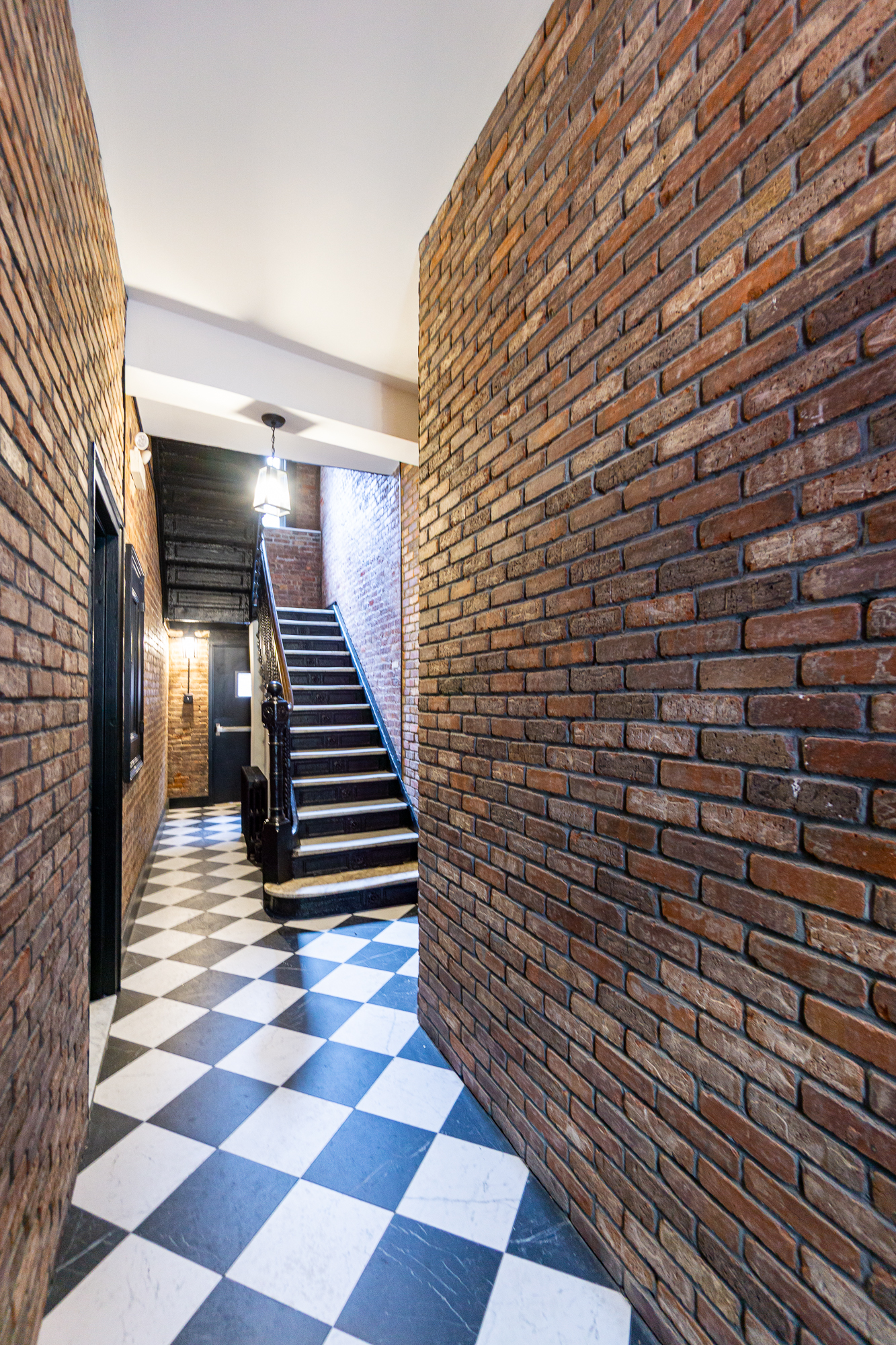 51 East 2nd Street, Unit 10 Manhattan, NY 10003 - Photo 13 of 16 a view of a hallway with stairs and wooden floor
