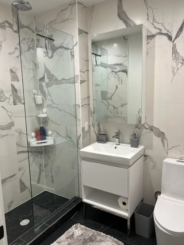 a bathroom with a sink toilet and shower