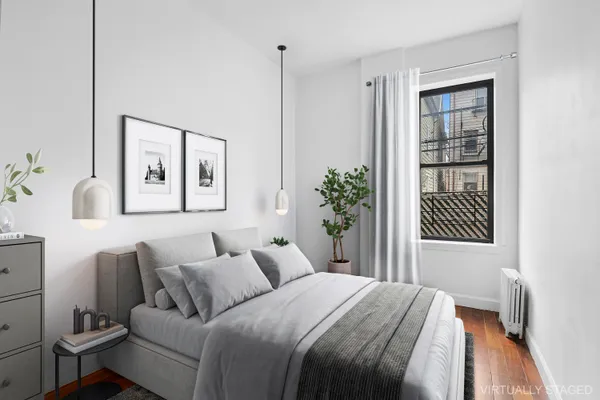 a bed room with a bed and a painting on the wall