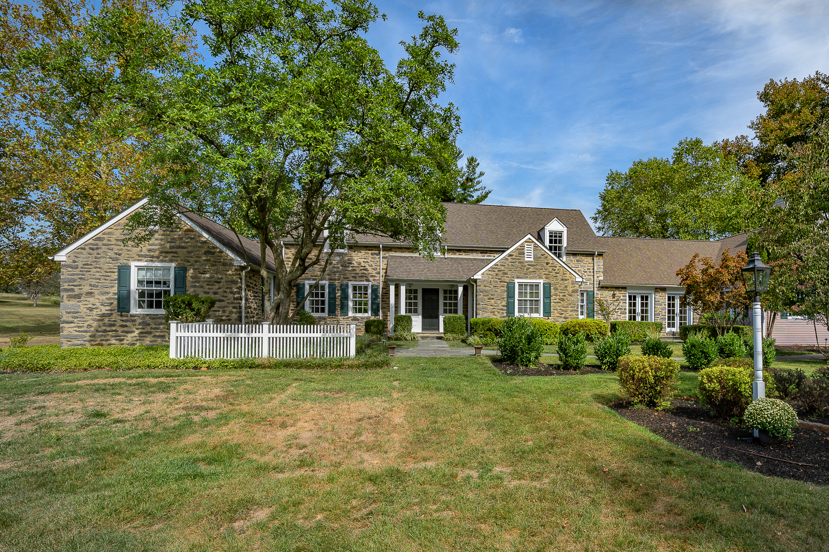 a front view of house with yard and green space