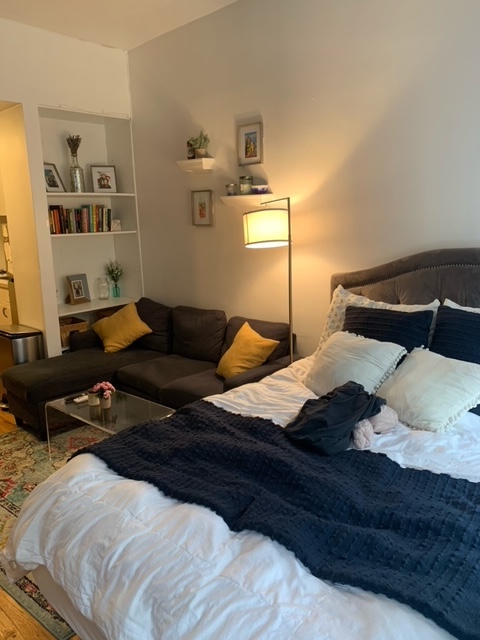 143 Sullivan Street, Unit 12 Manhattan, NY 10012 - Photo 6 of 11 a bedroom with a bed and a night stand