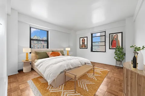 a bedroom with a large bed and a painting on the wall