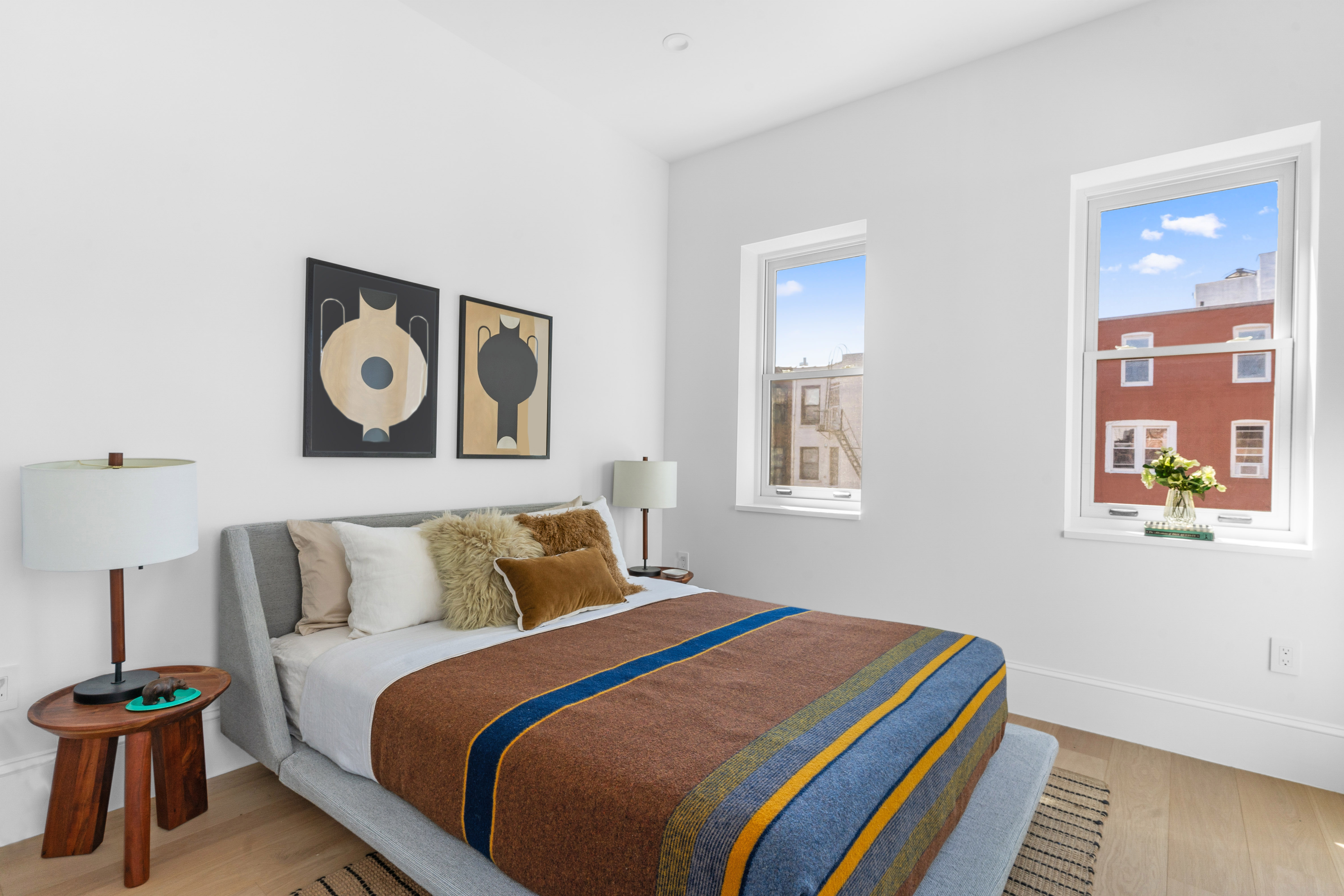 1370 Dean Street, Unit PHD Brooklyn, NY 11216 - Photo 6 of 12 a bedroom with a bed and painting on the wall