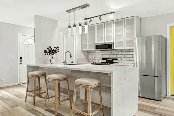 a kitchen with stainless steel appliances a refrigerator and a stove