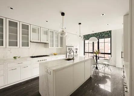 a kitchen with stainless steel appliances granite countertop a sink stove and white cabinets with wooden floor