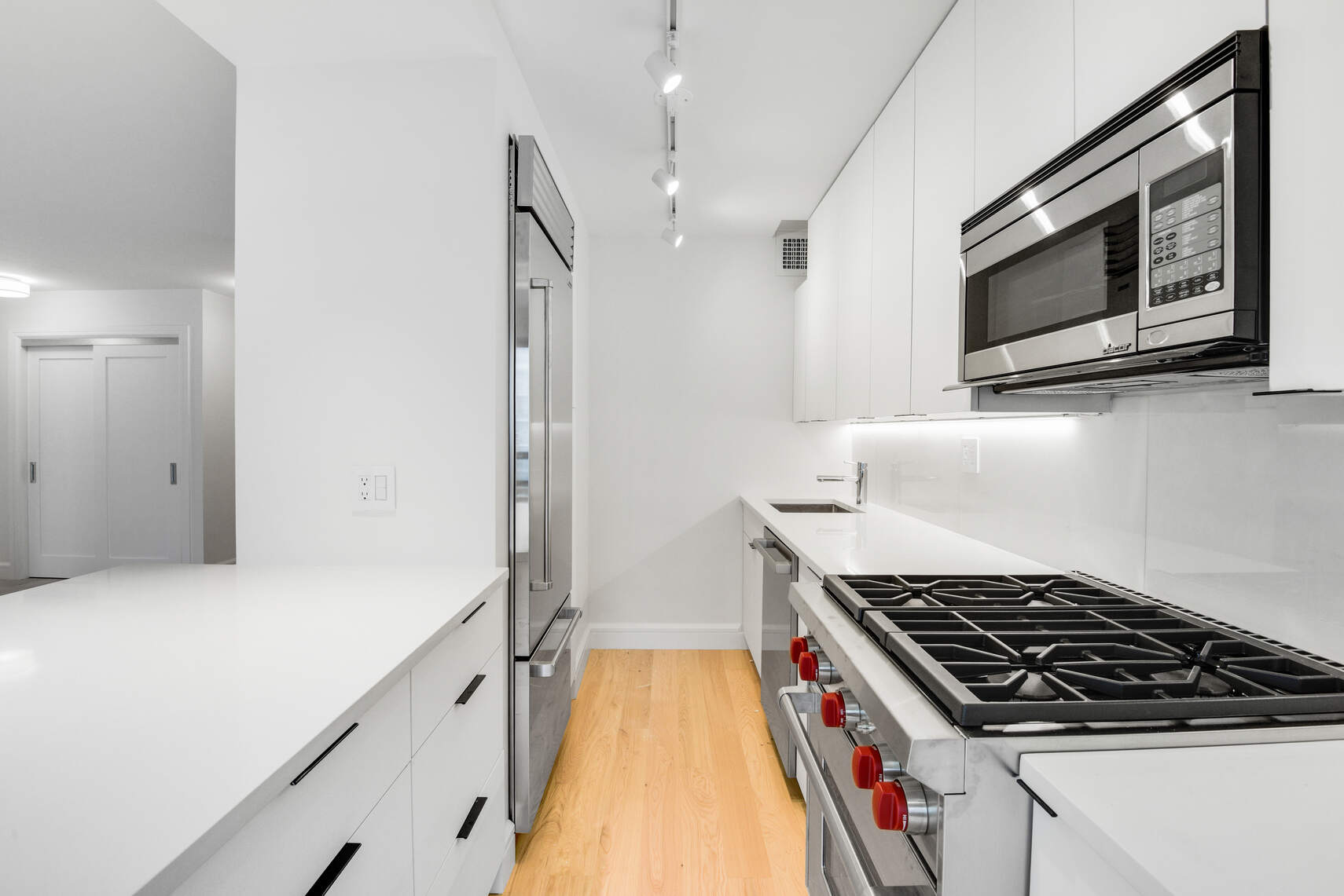 170 West End Avenue, Unit 12B Manhattan, NY 10023 - Photo 6 of 15 a kitchen with stainless steel appliances granite countertop a stove and a microwave