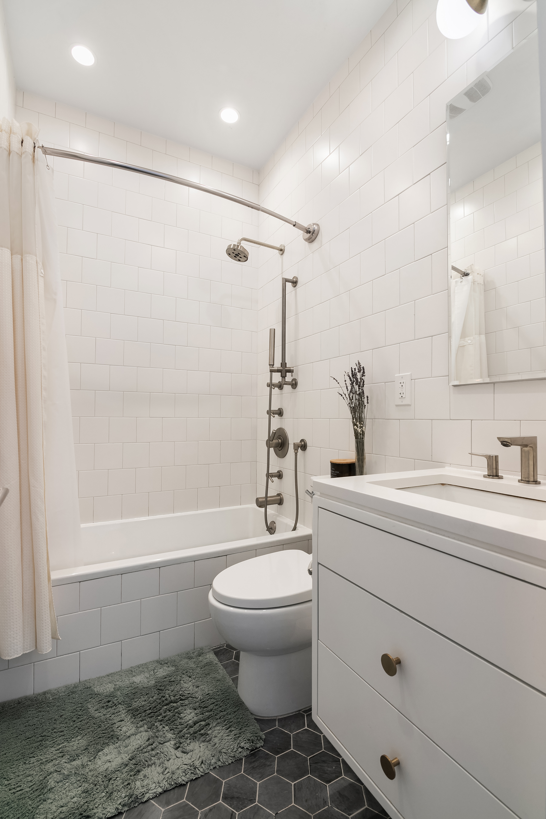 558 West 150th Street, Unit 301 Manhattan, NY 10031 - Photo 6 of 8 a bathroom with a sink a toilet and shower