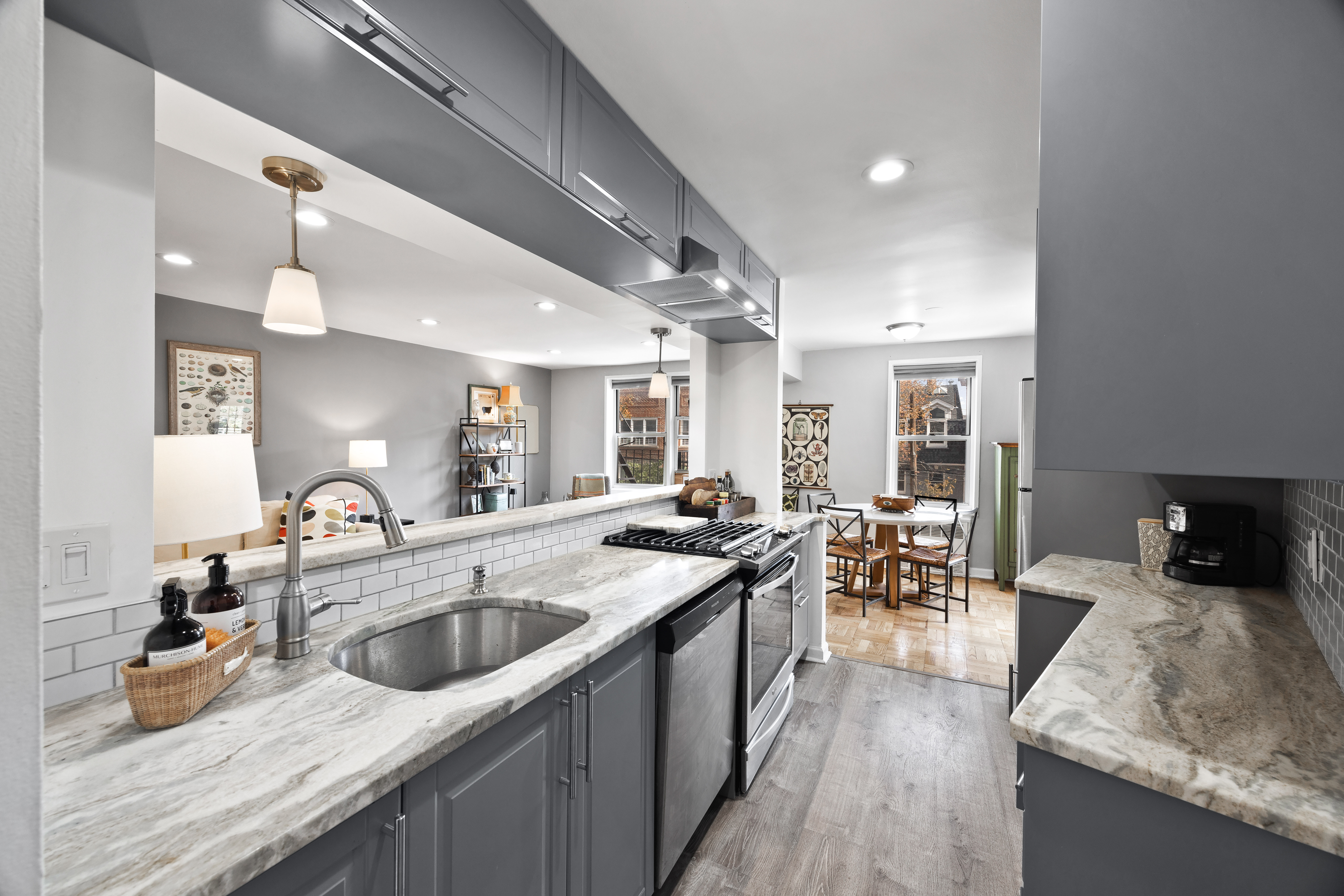255 Fieldston Terrace, Unit 2L Bronx, NY 10471 - Photo 13 of 32 a kitchen with sink a counter and chairs