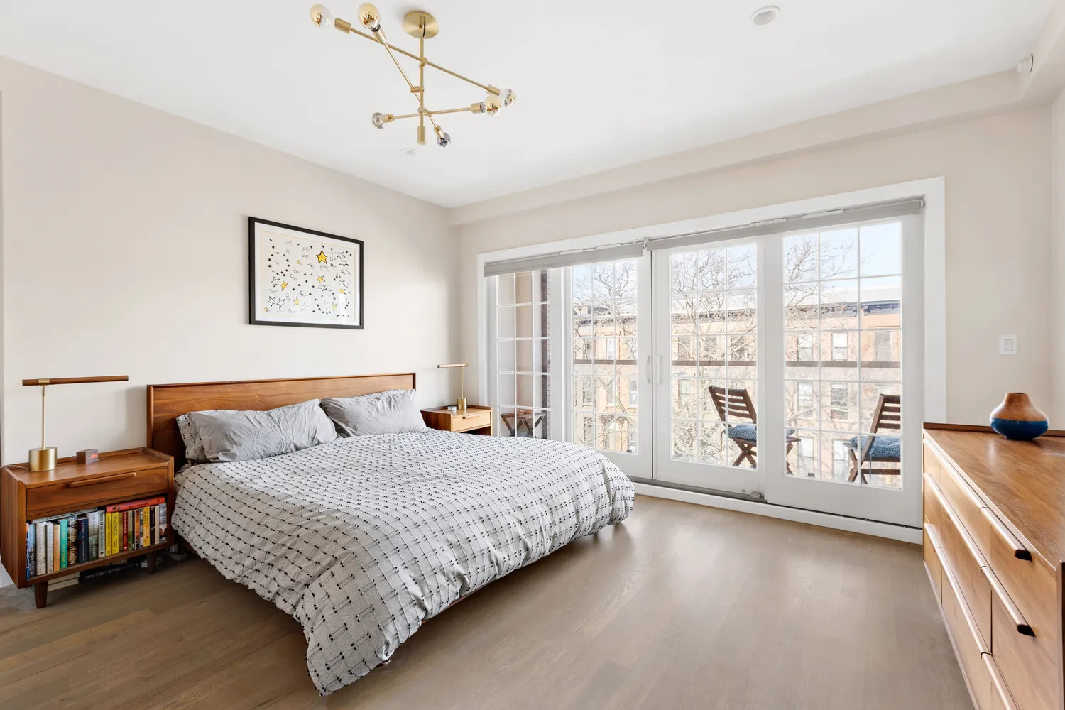 a living room with a bed furniture and next to a window
