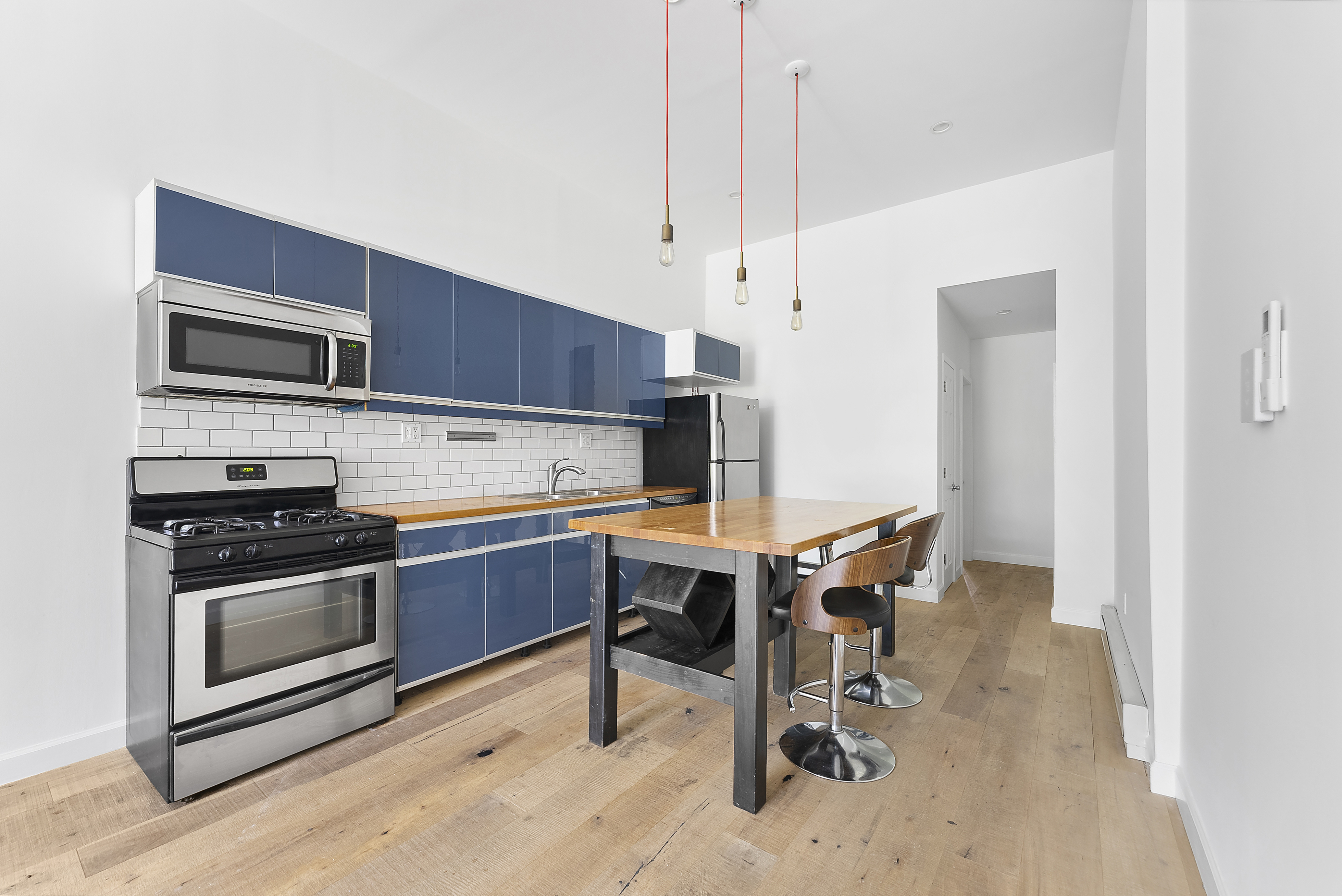 768 Hart Street, Unit 1 Brooklyn, NY 11237 - Photo 4 of 18 a kitchen with a stove a microwave and a area