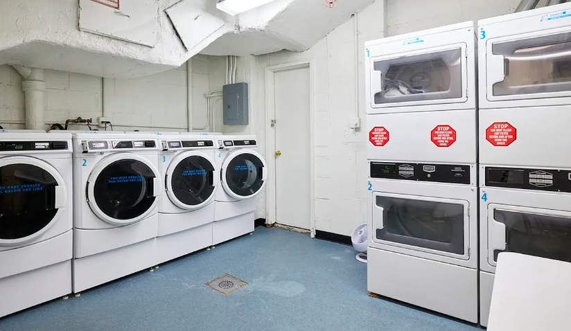 233 East 70th Street, Unit 11P Manhattan, NY 10021 - Photo 12 of 15 a utility room with dryer and washer