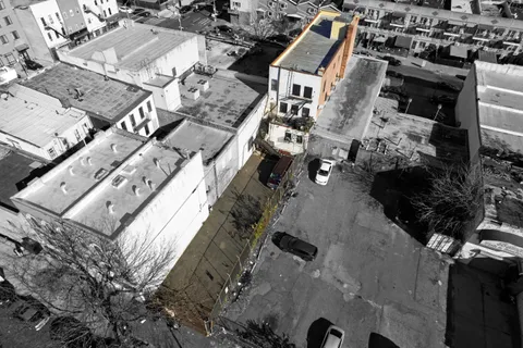 an aerial view of a house with a yard