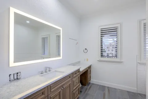 a spacious bedroom with a large bed and a wooden floor