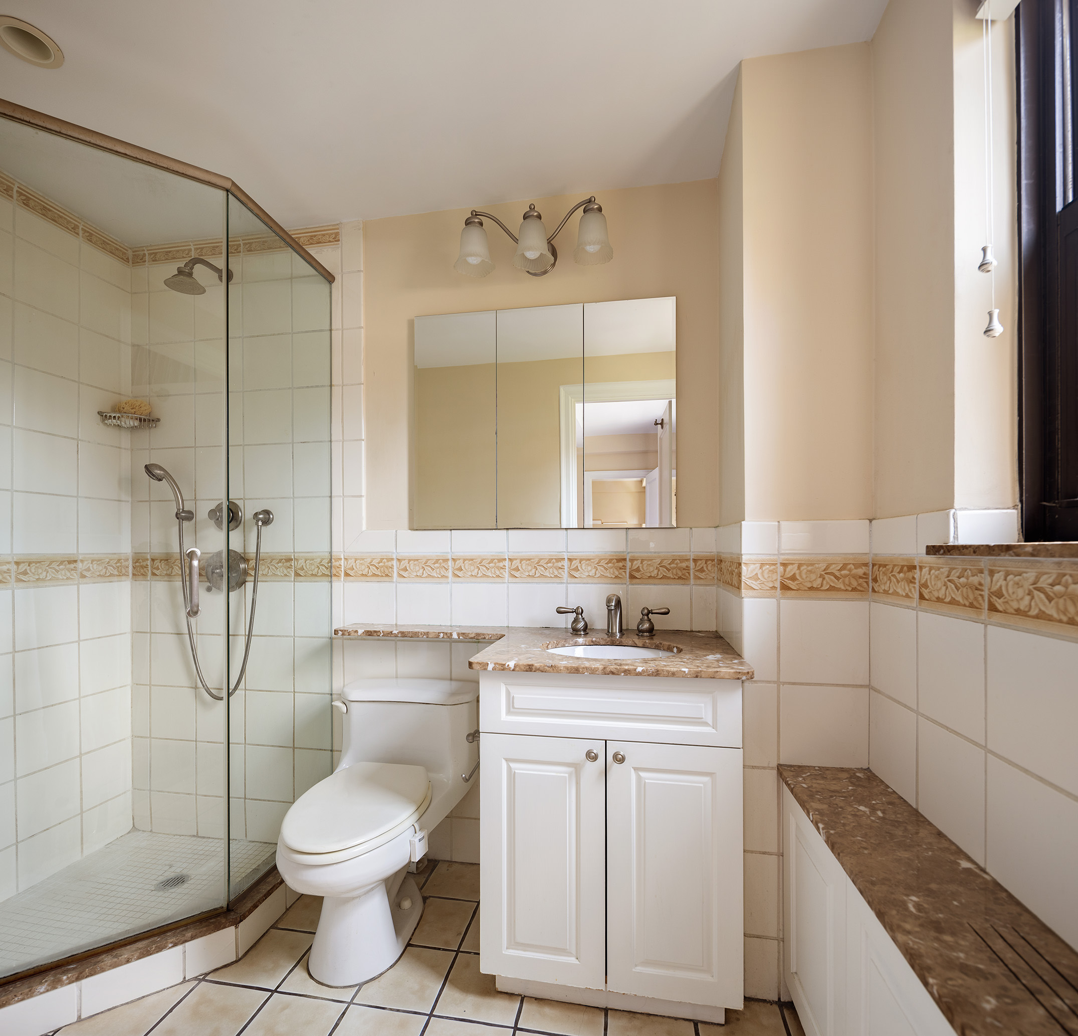 151 East 83rd Street, Unit 6D Manhattan, NY 10028 - Photo 8 of 14 a bathroom with a granite countertop sink toilet and shower