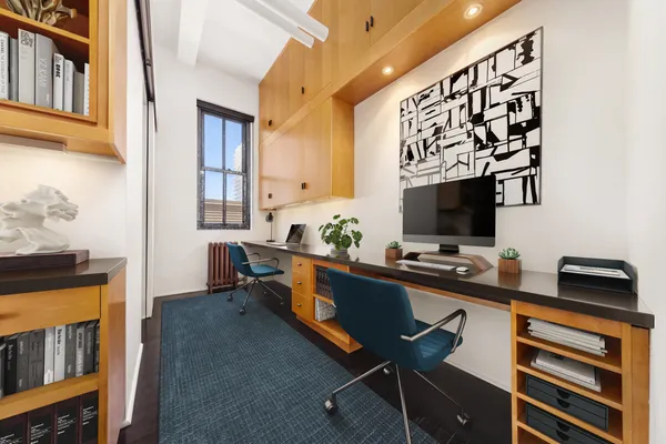 a living room with furniture a flat screen tv and a window