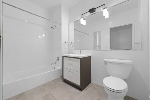 a bathroom with a sink a toilet and a mirror